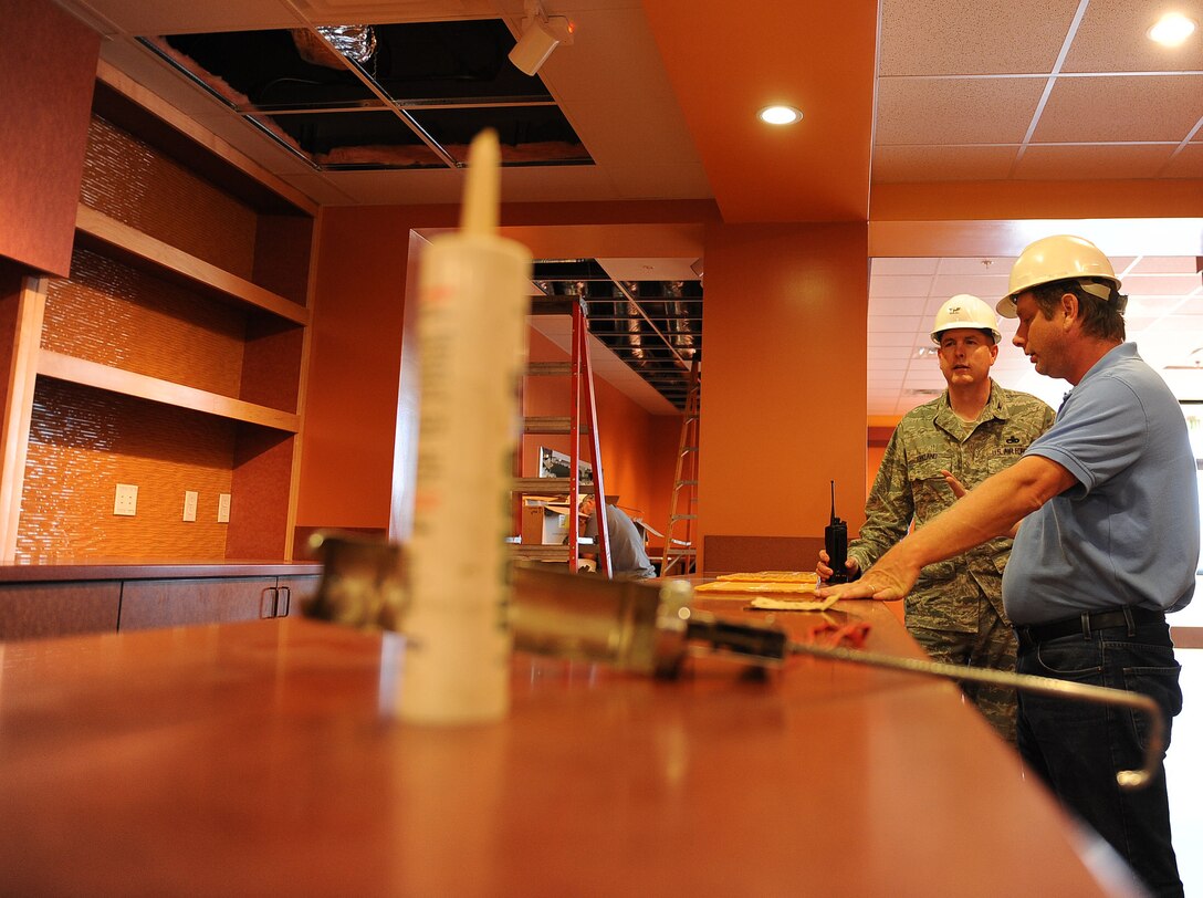 LANGLEY AIR FORCE BASE, Va. -- Joseph Sirois, civil engineer contractor, shows Col. Donald Kirkland, 633d Air Base Wing commander, the lounge area at Langley Lanes bowling center during the Base Civil Engineer Update Project Tour March 7. 633 CES is constructing and improving multiple facilities base-wide. (U.S. Air Force photo/Airman Rebecca Montez)