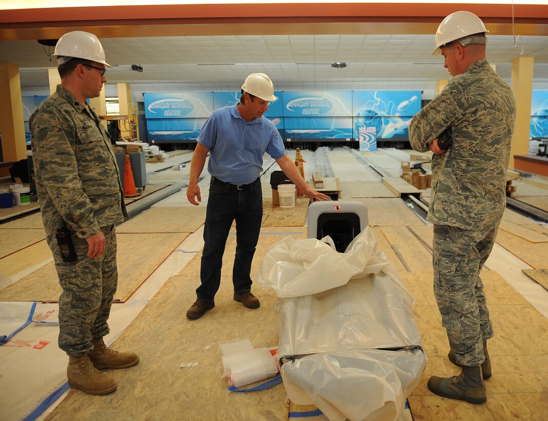LANGLEY AIR FORCE BASE, Va. -- Joseph Sirois, civil engineer contractor, shows Col. Donald Kirkland, 633d Air Base Wing commander, and Lt. Col. Jeffery Ullmann, 633d Civil Engineer Squadron commander, brand new bowling equipment at Langley Lanes during the Base Civil Engineer Update Project Tour March 7. 633 CES is constructing and improving multiple facilities base-wide. (U.S. Air Force photo/Airman Rebecca Montez)
