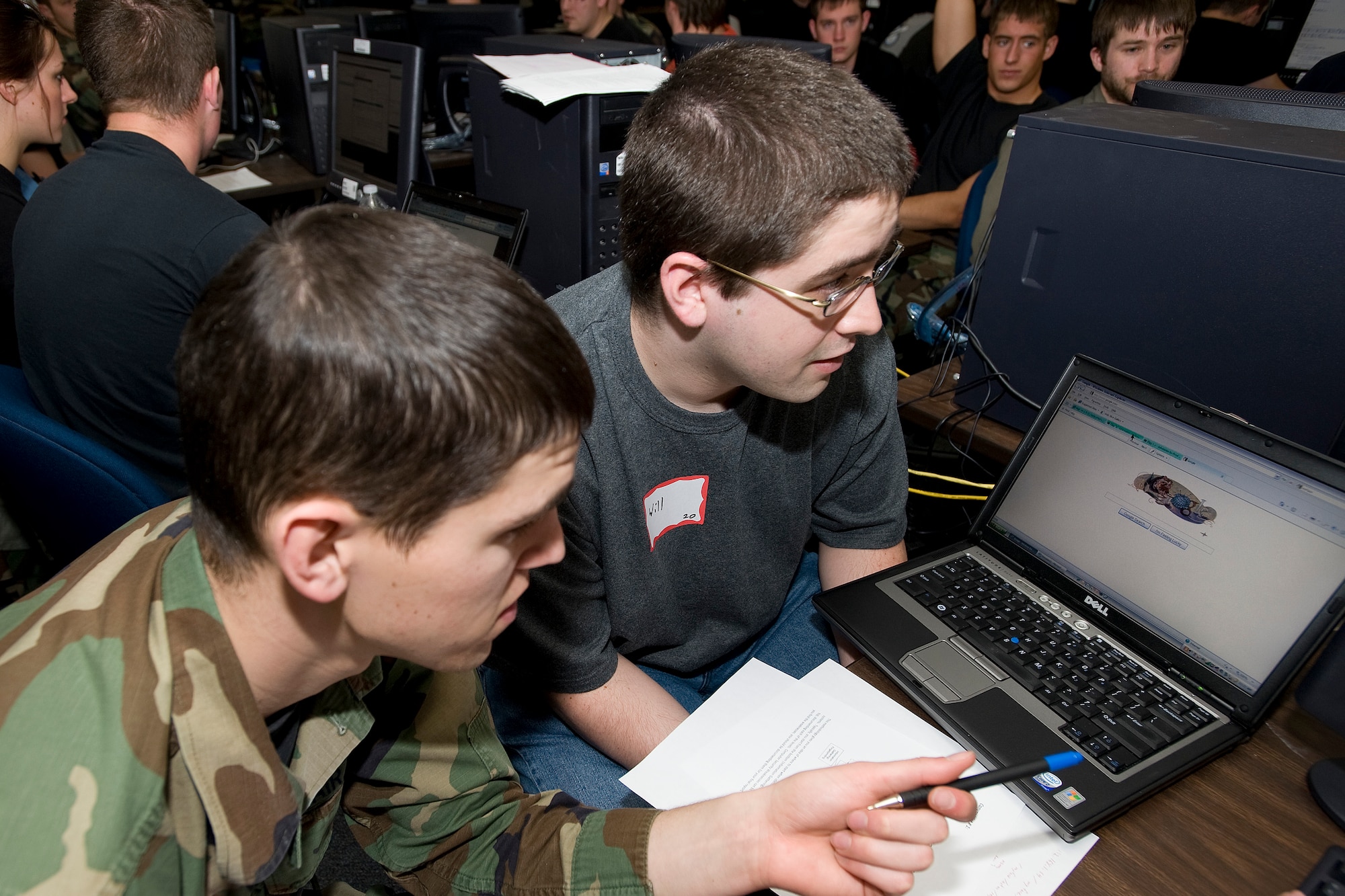 Cadet 1st Class Bryan Hanes and local student Will Mitchell participate in the Computer and Network Vulnerability Assessment Scenario at the Air Force Academy April 2, 2010. Scenarios challenged students to hunt down and identify weaknesses in system design and implementation for a fictional social networking Web site. (U.S. Air Force photo/Bill Evans)