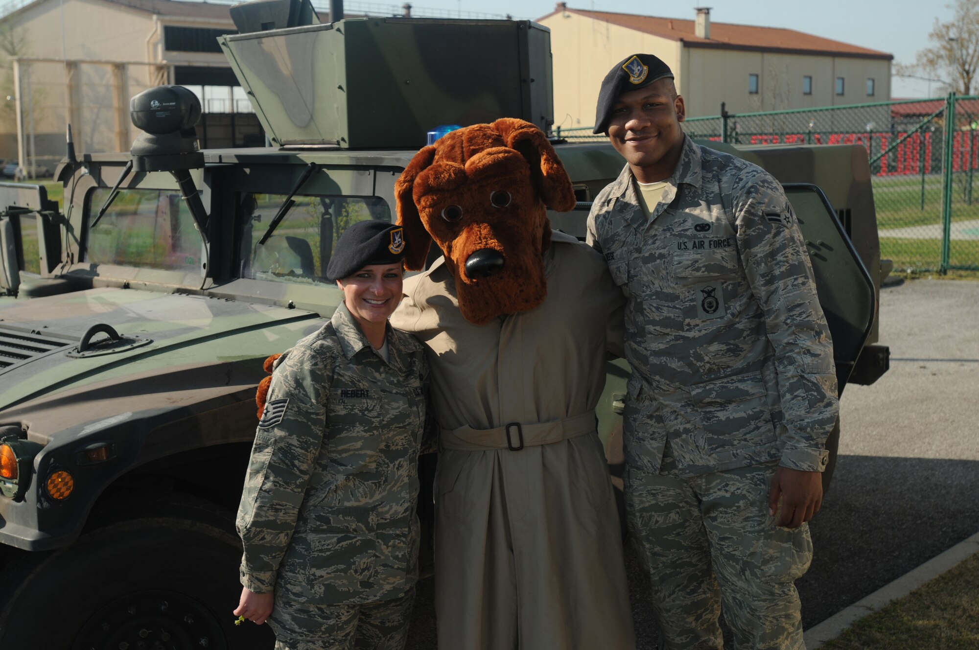 (Left to Right) Tech. Sgt. Natasha Herbet , McGruff the Crime Dog and Airman 1st Class Rashad Reese pose for a group picture at the Child Development Center April 8.  McGruff the Crime Dog visited the CDC as a part of the Month of the Military Child. (U.S. Air Force photo/Airman LaVel Sterling)