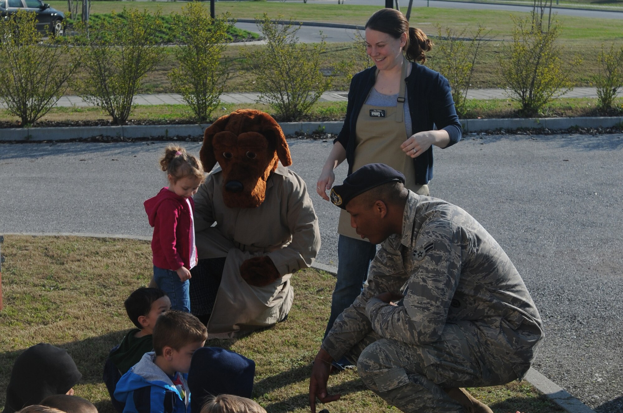 Airman 1st Class Rashad Reese, 31st Security Forces Squadron patrolman, assists McGruff the Crime Dog with entertaining the children of the Flight Line Child Development Center April 8. McGruff the Crime Dog visited the CDC as a part of the Month of the Military Child, which is designed to highlight children of the military and their parents.(U.S. Air Force photo/Airman LaVel Sterling)