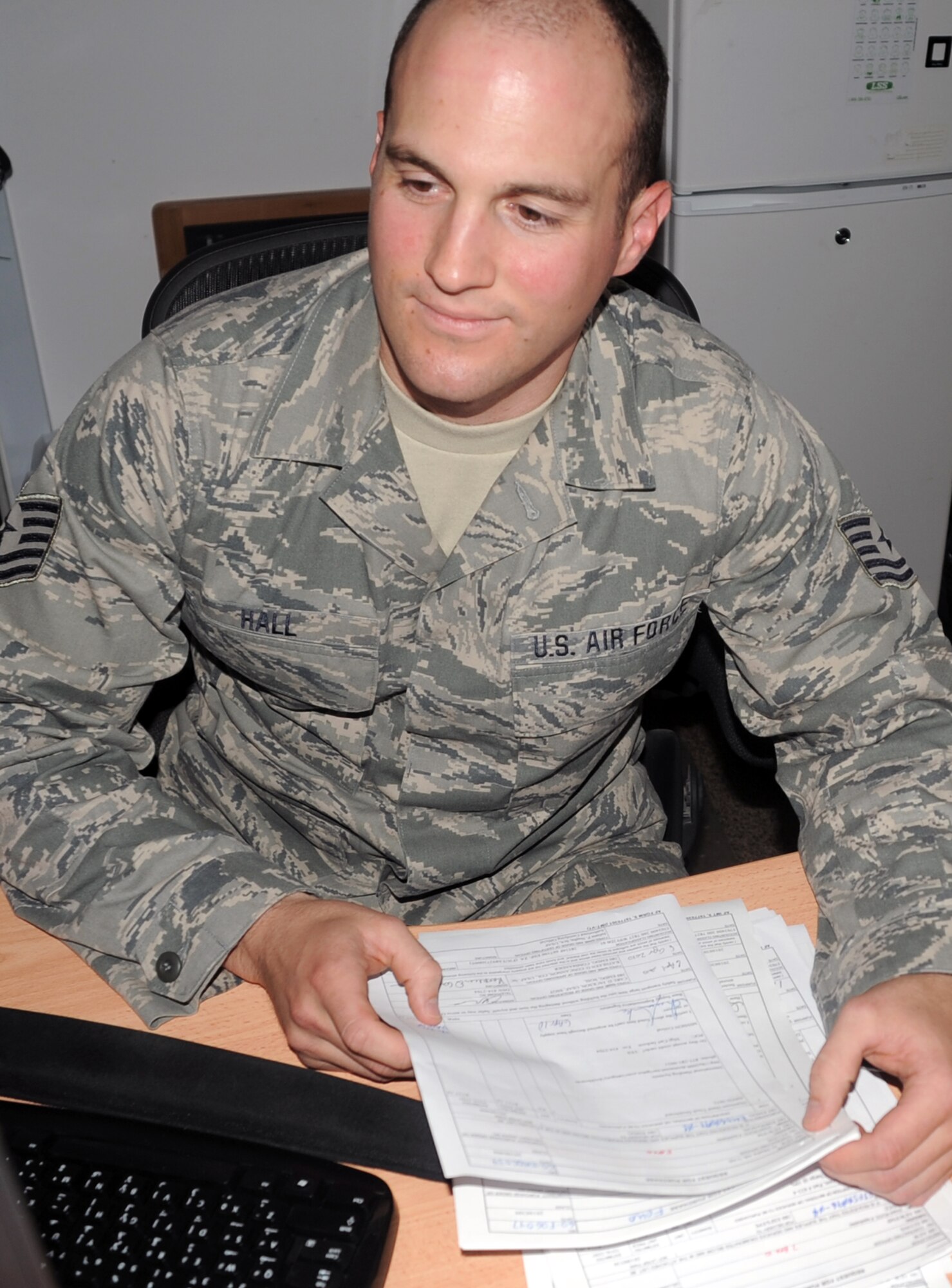 Tech. Sgt. Tyson Hall, a contracting officer with the 380th Expeditionary Contracting Squadron, works in his office at a non-disclosed base in Southwest Asia on April 8, 2010. He is deployed from the Wisconsin Air National Guard's 115th Fighter Wing at Truax Field in Madison. (U.S. Air Force Photo/Master Sgt. Scott T. Sturkol/Released)