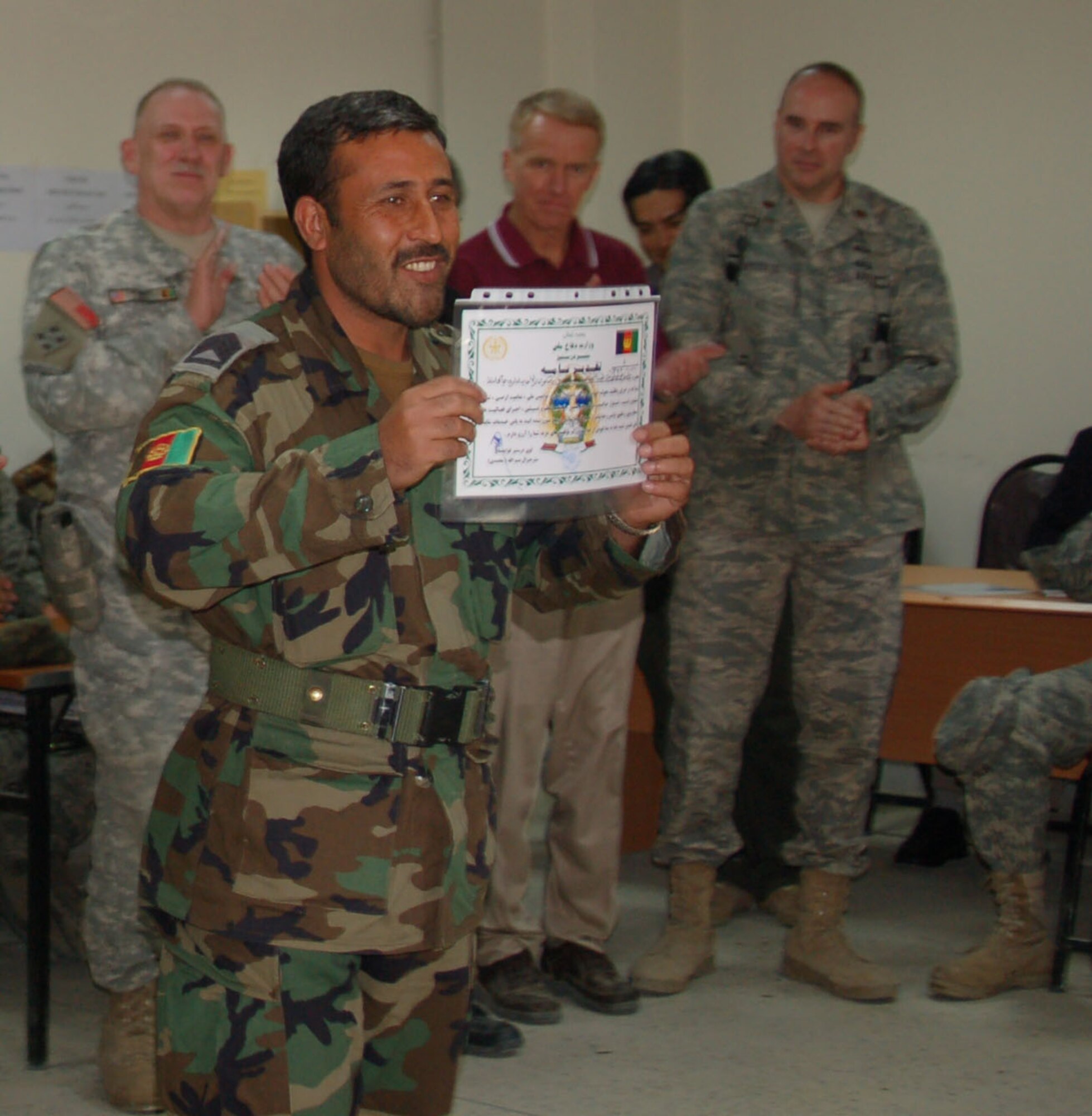 Members of the Afghan National Army Air Corps and the Afghan National Army recieve their training certificates on the Personnel Information Management System which has standardized and digitized the almost 3,000 Air Corps military personnel records. (US Air Force photo by Capt. Robert Leese/RELEASED)