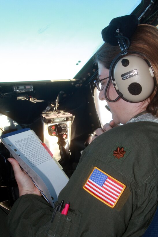 WRIGHT-PATTERSON AFB, Ohio - Maj. Rachel Daulton, 89th Airlift Squadron, completes an inflight checklist during a local C-5 Galaxy training mission April 1.  The local training is in preparation for an increased operations tempo in support of the surge in Afghanistan. (Air Force photo/Senior Airmen Mikhail Berlin)