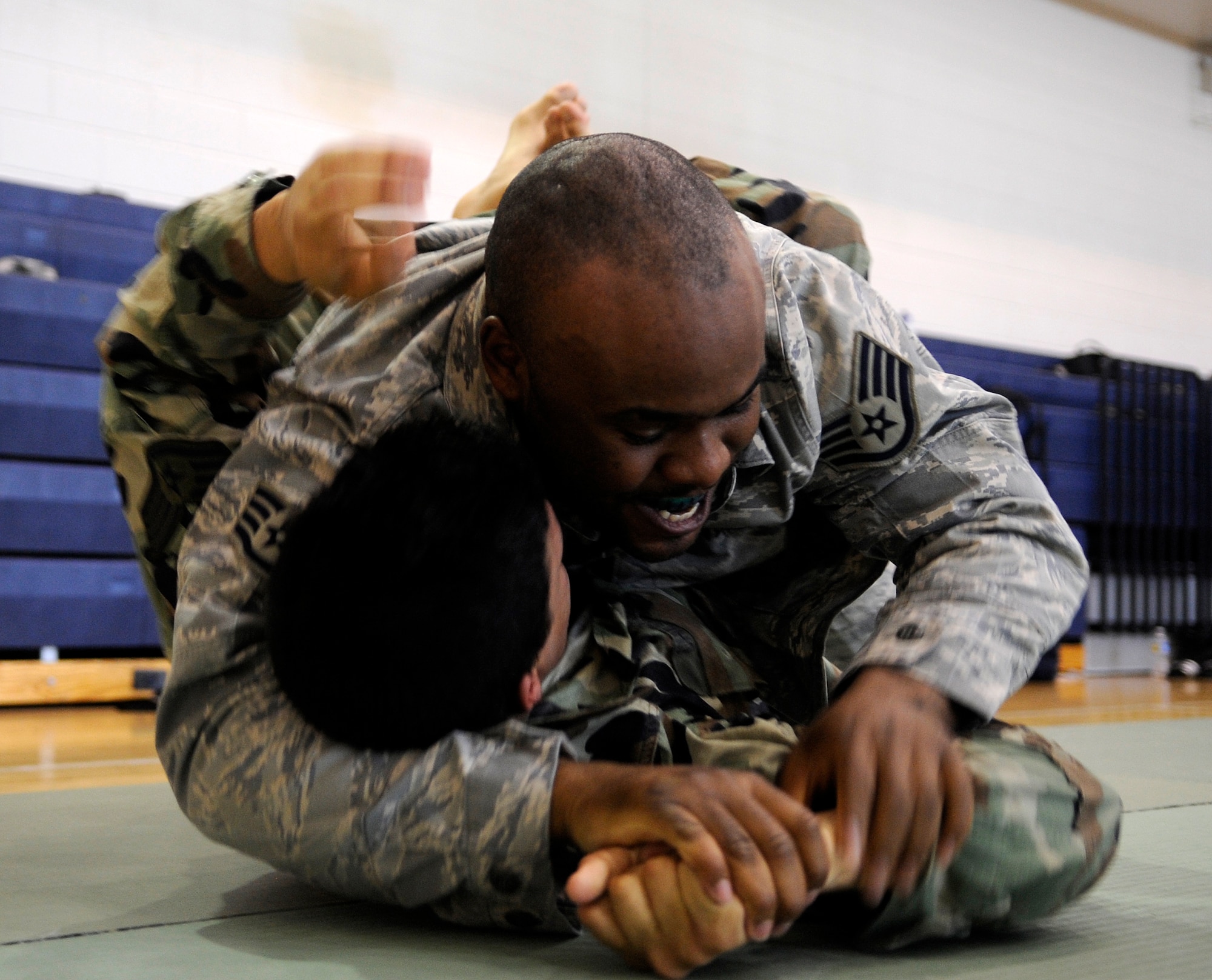 LANGLEY AIR FORCE BASE, Va. - Staff Sgt. Michael McQueen (top), 633d Communications Squadron, and Staff Sgt. Creighton Chilcote (bottom), 82nd Communications Support Squadron, practice combative maneuvers during Modern Combatives training April 7. For the first time, Langley and Fort Eustis Service members merged in a session of combatives, which is the Army's version of hand-to-hand combat training. (U.S. Air Force photo/Senior Airman Dana Hill)
