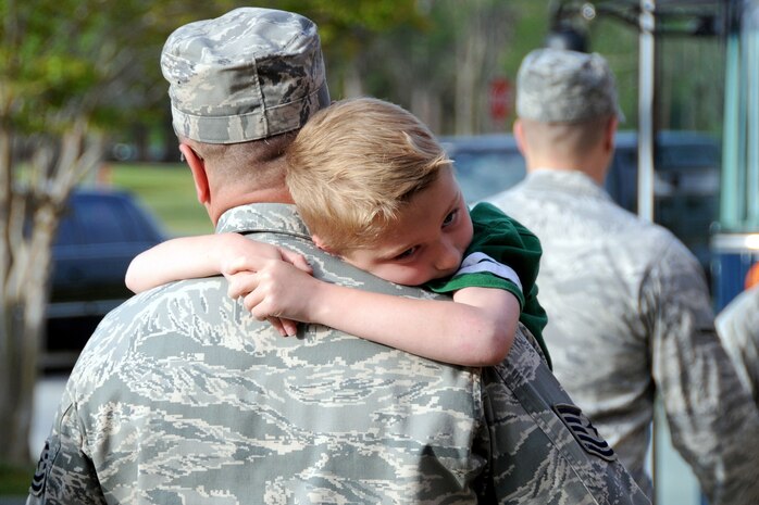 Tech. Sgt. Randall Fontenot carries his son Zach toward a bus before saying goodbye to his family April 8, 2010, outside the 628th Security Forces building at Joint Base Charleston, S.C. Approximately 30 Airmen from the squadron departed April 8 for deployment training at Fort Wolters, Texas, after which they will deploy to the Middle East for approximately 179 days. Sergeant Fontenot is a flight chief with the 628 SFS and a team leader with the deploying group of Airmen. (U.S. Air Force photo/Staff Sgt. Daniel Bowles)
