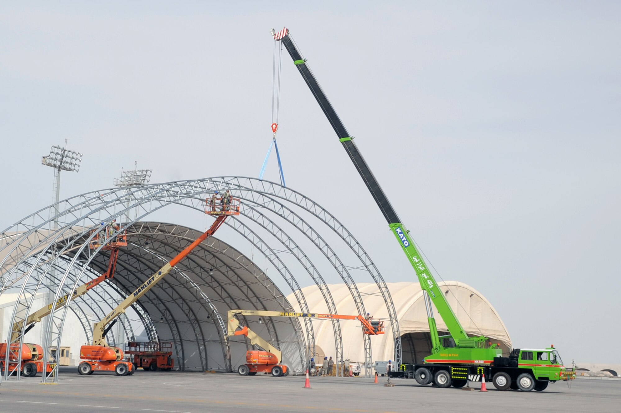 Airmen from the 380th Expeditionary Civil Engineer Squadron work on a hangar upgrade project on the flightline for the 380th Air Expeditionary Wing at a non-disclosed base in Southwest Asia on April 5, 2010. The project will increase hangar space for aircraft deployed in support of the 380th AEW whick includes the KC-10 Extender, E-3 Sentry, RQ-4 Global Hawk and the U-2 Dragon Lady aircraft. The 380th AEW supports operations Iraqi Freedom and Enduring Freedom and the Combined Joint Task Force-Horn of Africa. (U.S. Air Force Photo/Master Sgt. Scott T. Sturkol)