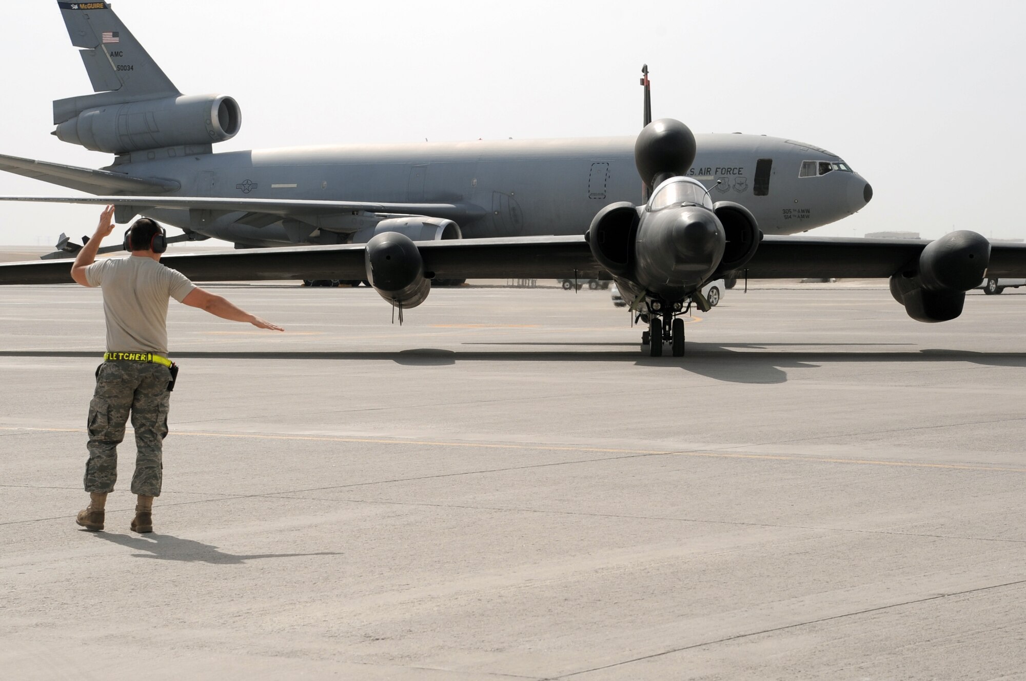 A maintenance Airman from the 380th Expeditionary Aircraft Maintenance Squadron Dragon aircraft maintenance unit guides a pilot from the 99th Expeditionary Reconnaissance Squadron in a U-2 Dragon Lady to a parking space at non-disclosed base in Southwest Asia after completing a combat mission in the U.S. Central Command area of responsibility April 5, 2010. The U-2 is deployed from Beale Air Force Base, Calif. The 99th ERS, as part of the 380th Air Expeditionary Wing, supports operations Iraqi Freedom and Enduring Freedom and the Combined Joint Task Force-Horn of Africa. (U.S. Air Force Photo/Master Sgt. Scott T. Sturkol/Released)
