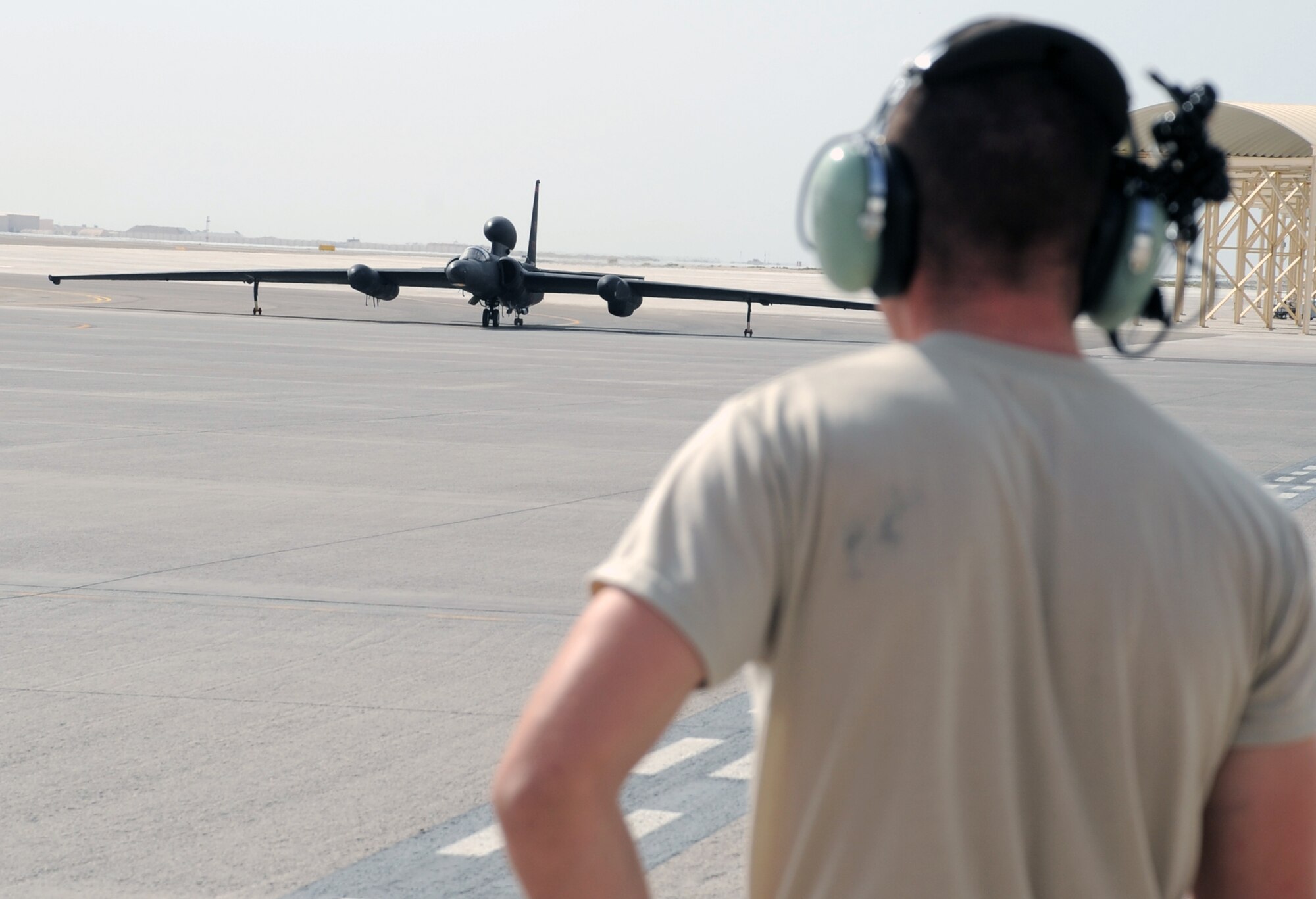 A maintenance Airman from the 380th Expeditionary Aircraft Maintenance Squadron Dragon aircraft maintenance unit watches as a pilot from the 99th Expeditionary Reconnaissance Squadron guides a U-2 Dragon Lady to a parking space at non-disclosed base in Southwest Asia after completing a combat mission in the U.S. Central Command area of responsibility April 5, 2010. The U-2 is deployed from Beale Air Force Base, Calif. The 99th ERS, as part of the 380th Air Expeditionary Wing, supports operations Iraqi Freedom and Enduring Freedom and the Combined Joint Task Force-Horn of Africa. (U.S. Air Force Photo/Master Sgt. Scott T. Sturkol/Released)