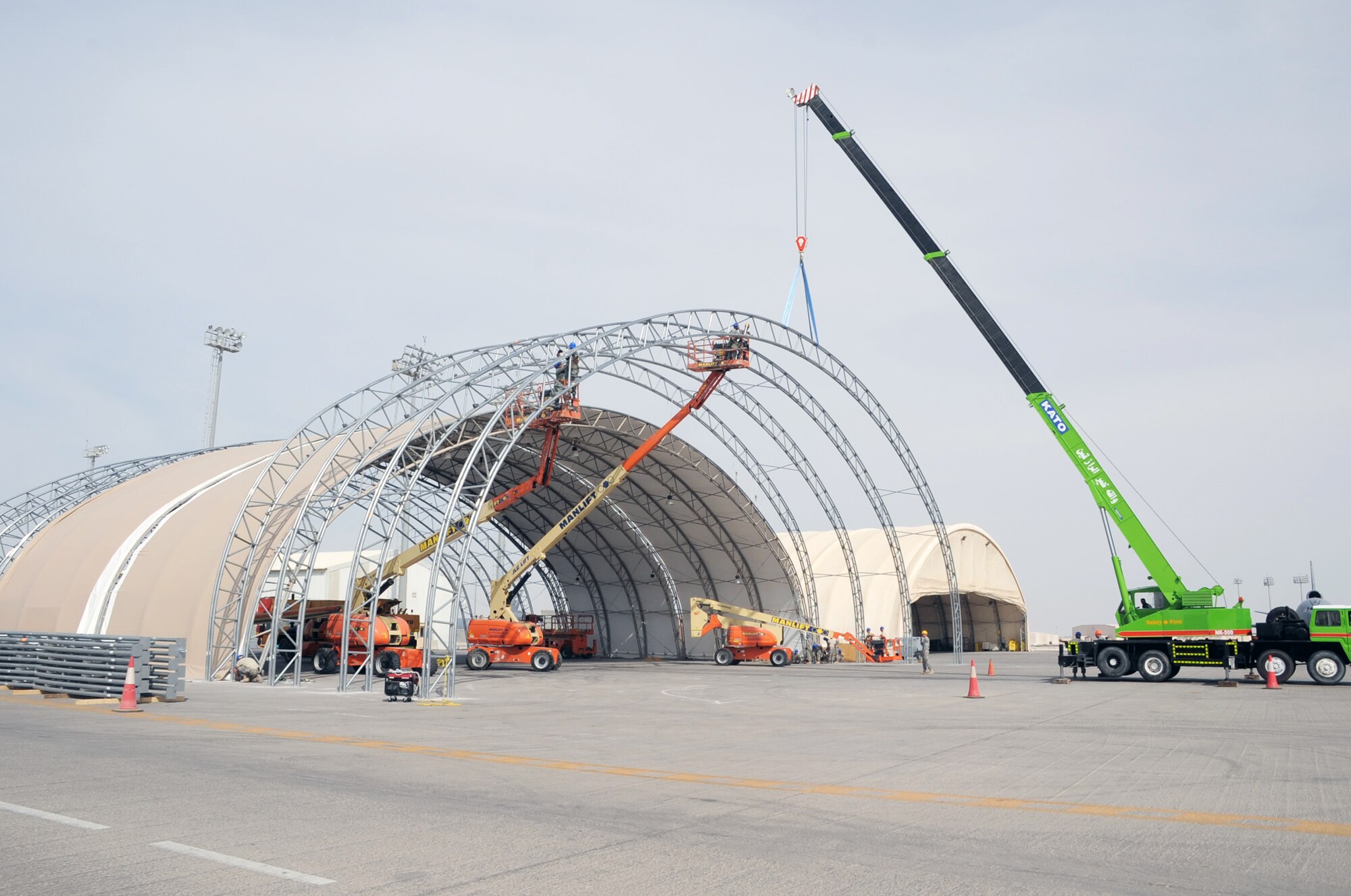 Airmen from the 380th Expeditionary Civil Engineer Squadron work on a hangar upgrade project on the flightline for the 380th Air Expeditionary Wing at a non-disclosed base in Southwest Asia on April 5, 2010. The project will increase hangar space for aircraft deployed in support of the 380th AEW whick includes the KC-10 Extender, E-3 Sentry, RQ-4 Global Hawk and the U-2 Dragon Lady aircraft. The 380th AEW supports operations Iraqi Freedom and Enduring Freedom and the Combined Joint Task Force-Horn of Africa. (U.S. Air Force Photo/Master Sgt. Scott T. Sturkol)