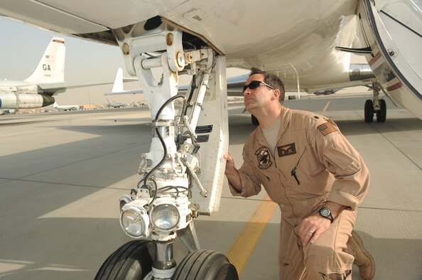 Navy Cmdr. Rich Ross, 379th Expeditionary Operations Group C-20 pilot, conducts a pre-flight inspection on a C-20 aircraft before takeoff at an air base in Southwest Asia, March 31, 2010. (U.S. Air Force photo by Tech. Sgt. Michelle Larche)
