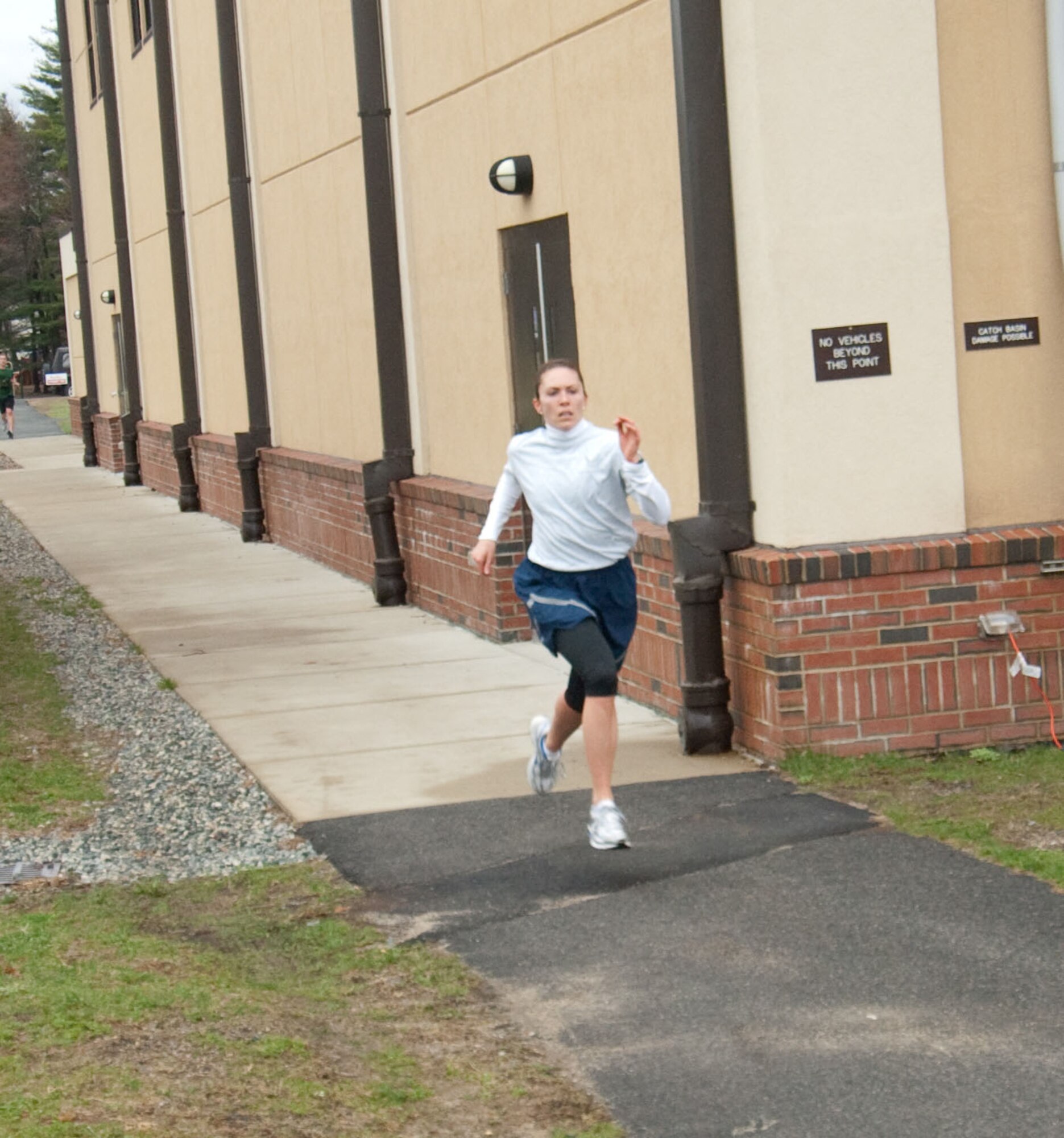 HANSCOM AIR FORCE BASE, Mass. - Capt. Alison Anders nears the finish line to take first place in the female category during the Air Force Assistance Fund 5K Fun Run. Captain Anders finished in 22 minutes and 36 seconds. The run, which took place on April 1, was an event open to all Hanscom personnel to raise awareness of the AFAF. (U.S. Air Force photo by Rick Berry)