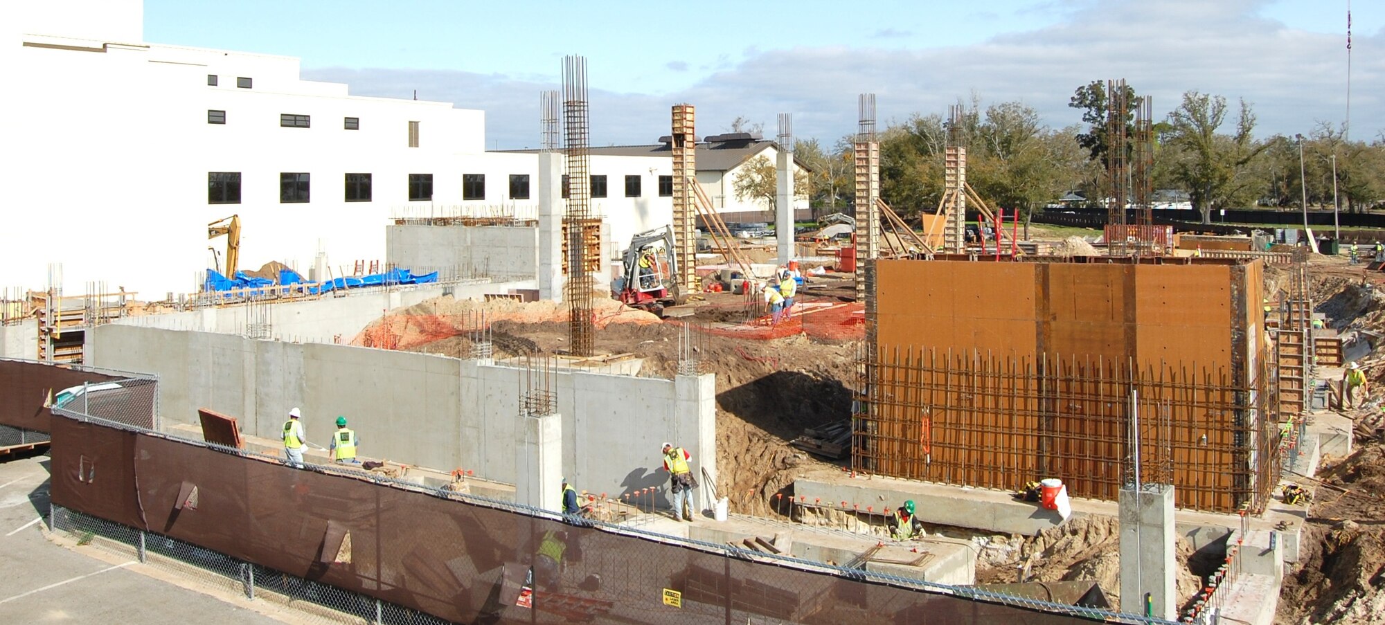 W.G. Yates and Sons Construction Company employees continue work on the 81st Medical Group Hospital’s new inpatient tower March 26. Major elements now visible include elevator shafts, left background and right foreground, foundation retention wall in the foreground, and many structural columns.  The tower is scheduled to be completed in September 2011.  (U.S. Air Force photo by Steve Pivnick)