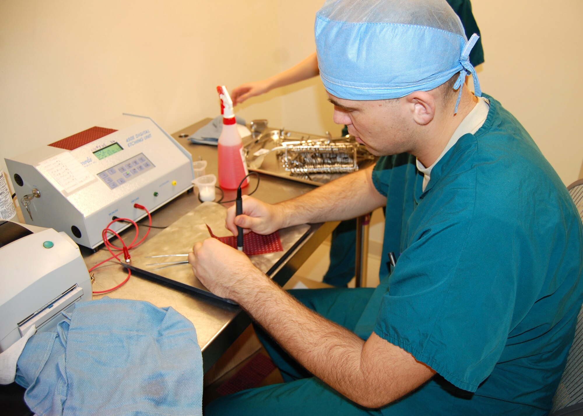 Airman 1st Class Karol Kowalczuk, 81st Surgical Operations Squadron, electrochemically etches a two-dimensional bar code on a surgical instrument March 26 in central sterile supply.  With the bar codes instruments can be individually tracked and information is readily available, such as when they were last used or sterilized and in which surgical package they are located.  (U.S. Air Force photo by Steve Pivnick)