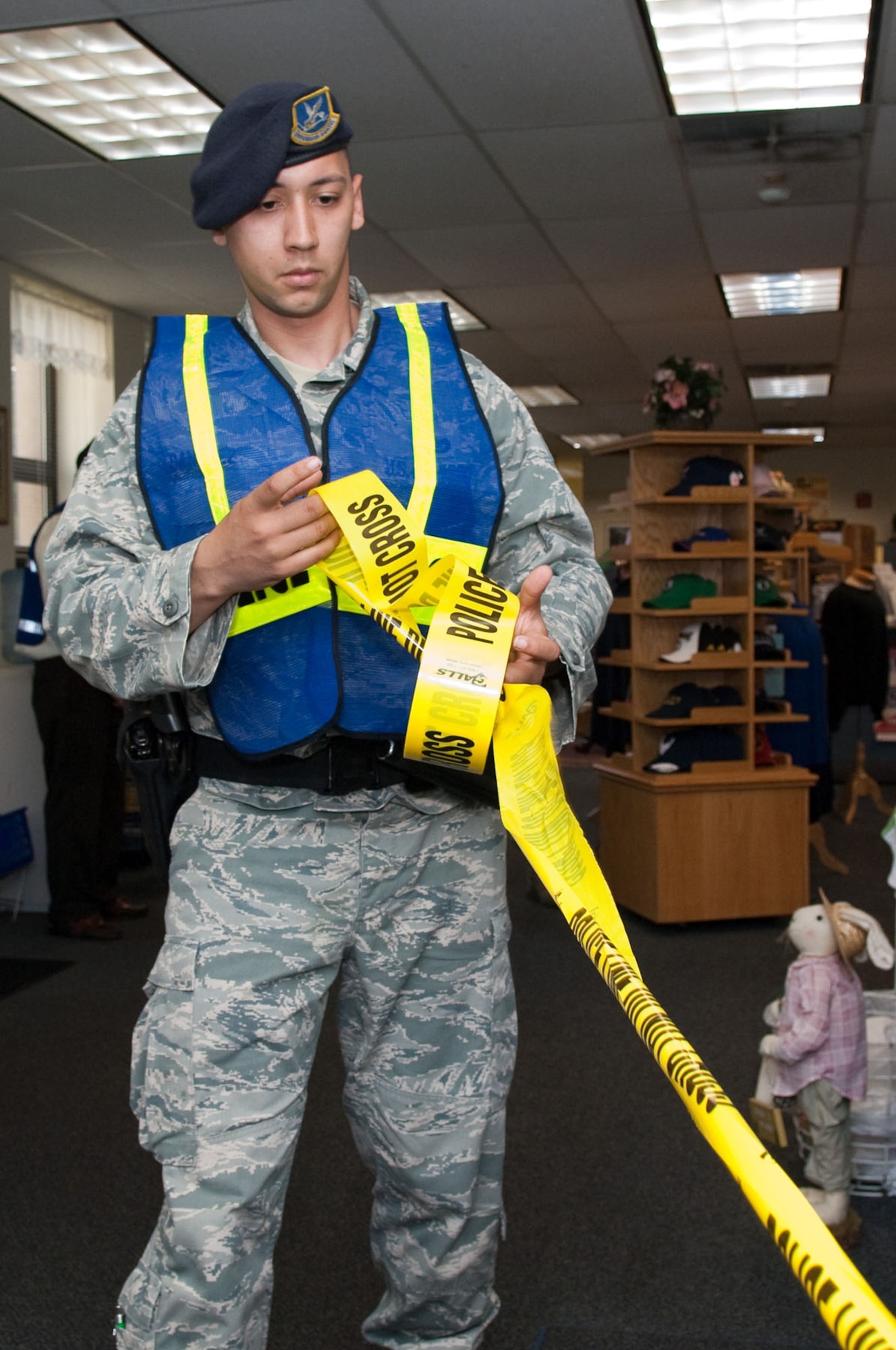 HANSCOM AIR FORCE BASE, Mass. - Senior Airman Romeo Sanchez secures the area during the robbery exercise scenario that took place in the Information Tickets and Tours office as part of the Base Readiness Exercise on April 7. (U.S. Air Force photo by Rick Berry)