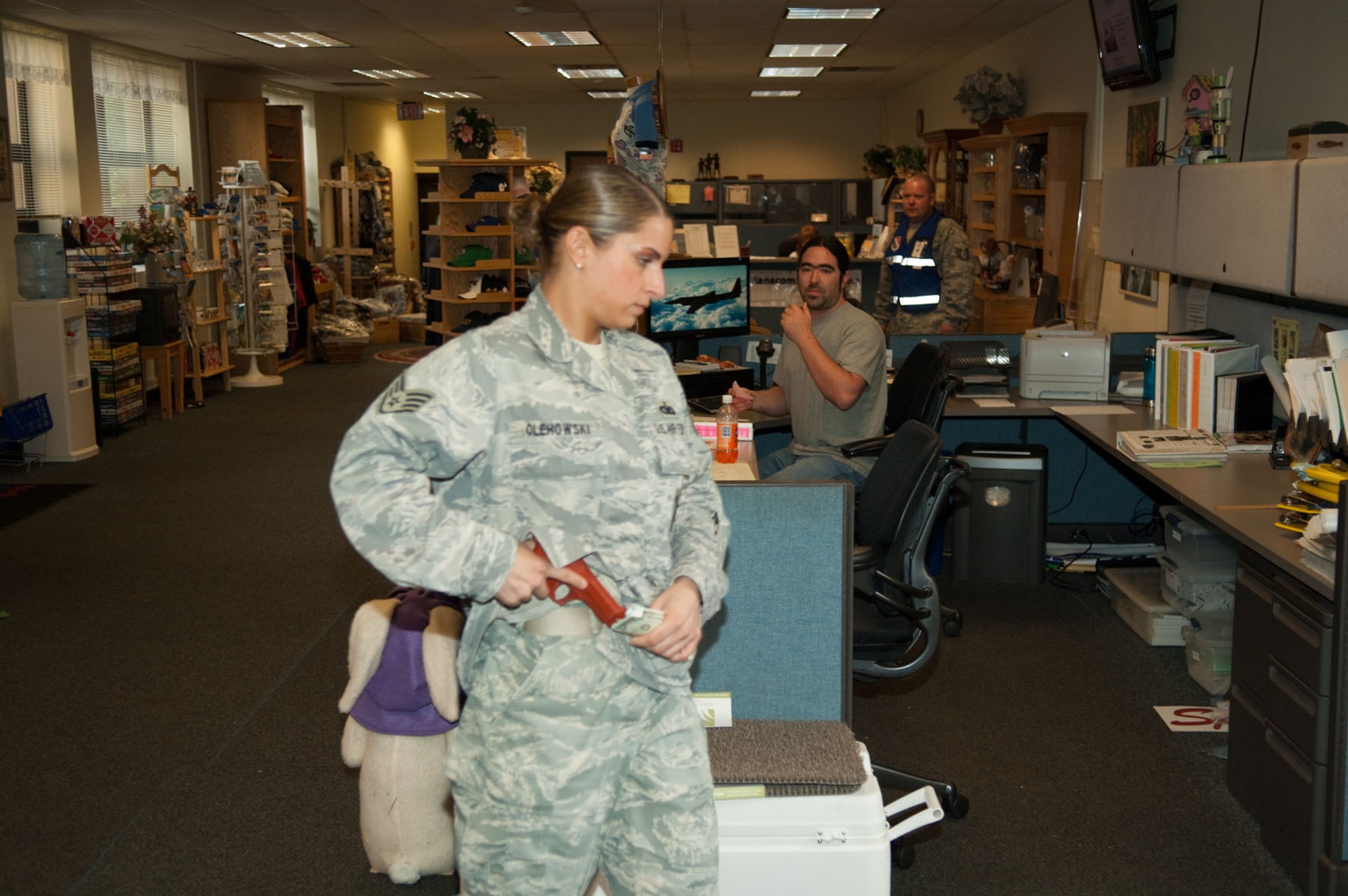 HANSCOM AIR FORCE BASE, Mass. - Staff Sgt. Nadia S. Olehowski, from 66th Security Forces, plays the role of a robber at the Information Tickets and Tours office as part of the Base Readiness Exercise on April 7. (U.S. Air Force photo by Rick Berry)