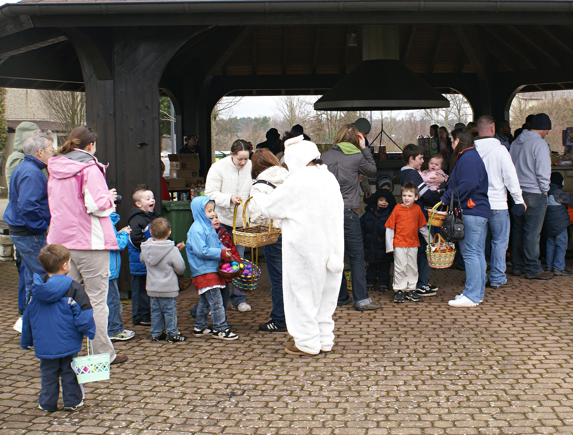SPANGDAHLEM AIR BASE, Germany – The Easter bunny passes out candy to children as they’re standing in line for hotdogs and chips after an Easter egg hunt April 4. About 750 people attended the free event, open to all 52nd Fighter Wing members. (photo/Mark Geairn)