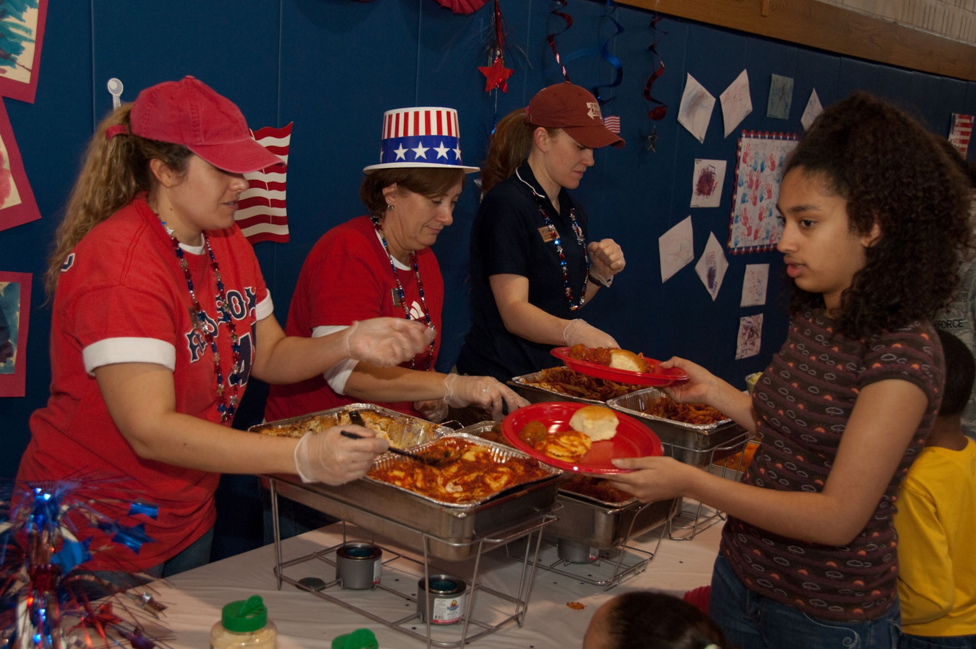 HANSCOM AIR FORCE BASE, Mass. - Kids line up to be served pasta during Family Pasta Night on April 1 at youth center. The event was held to celebrate the beginning of the Month of the Military Child. (U.S. Air Force photo by Rick Berry)