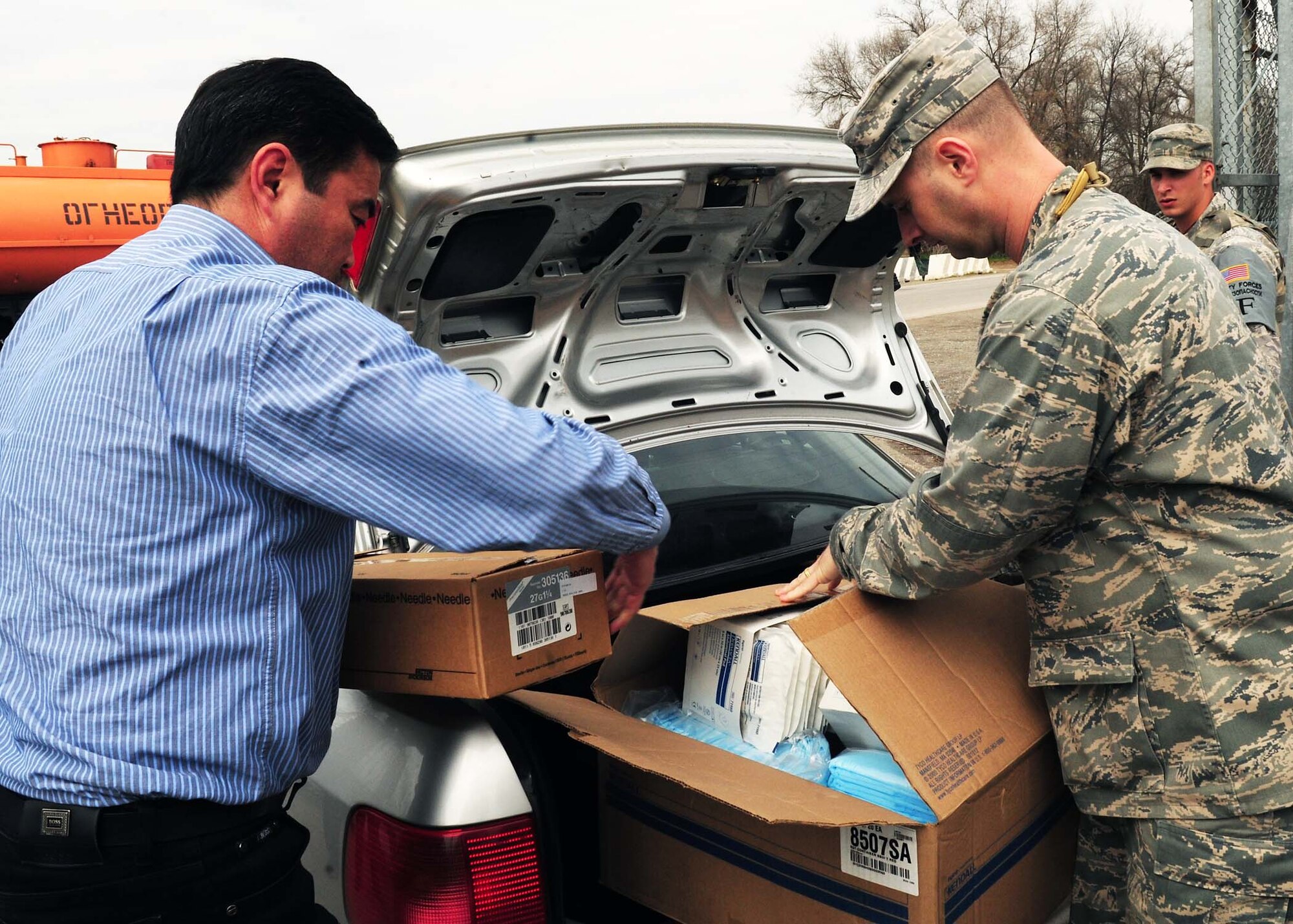 The 376th Expeditionary Medical Group personnel, at the Transit Center at Manas, Kyrgyzstan, deliver needed medical supplies April 8, 2010 to personnel from the National Surgical Center and the National Center of Traumatology and Orthopedics. The 376th EMDG was able to gather the humanitarian aid supplies and distribute them in a little over an hour after the request for supplies was made. The medical supplies include dressing, gauze, adhesive tape, sutures, disinfectant, antibiotics, antiseptics and IV solution. (U.S. Air Force photo/Senior Airman Nichelle Anderson/released)
