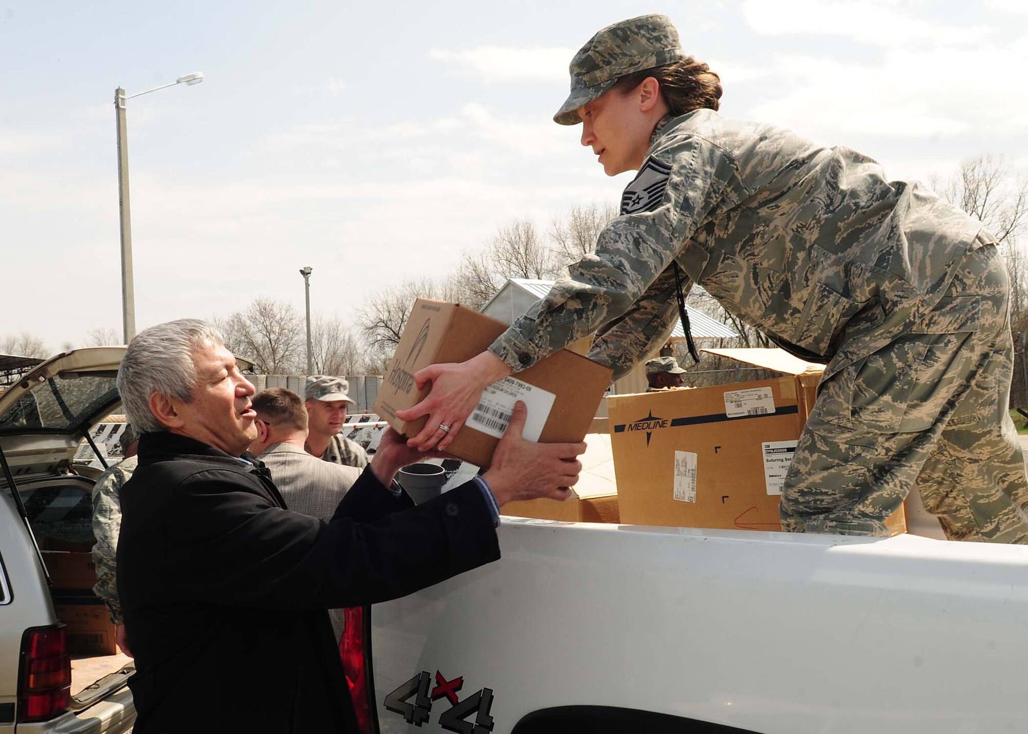 The 376th Expeditionary Medical Group personnel, at the Transit Center at Manas, Kyrgyzstan, deliver needed medical supplies April 8, 2010 to personnel from the National Surgical Center and the National Center of Traumatology and Orthopedics. The 376th EMDG was able to gather the humanitarian aid supplies and distribute them in a little over an hour after the request for supplies was made. The medical supplies include dressing, gauze, adhesive tape, sutures, disinfectant, antibiotics, antiseptics and IV solution. (U.S. Air Force photo/Senior Airman Nichelle Anderson/released)
