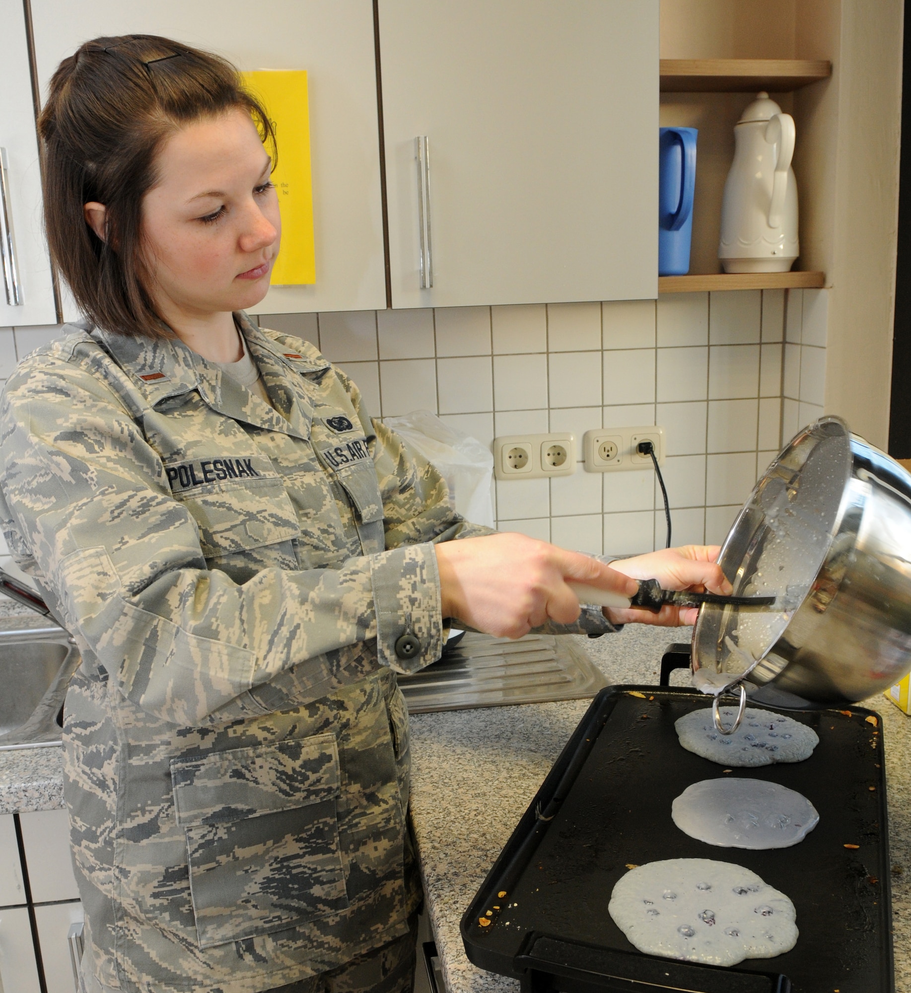 SPANGDAHLEM AIR BASE, Germany – 2nd Lt. Kathleen Polesnak, 52nd Fighter Wing deputy sexual assault response coordinator, prepares pancakes for a Sexual Assault Awareness Month pancake breakfast April 6. Money collected at the breakfast will benefit sexual assault victims in the Eifel region. (U.S. Air Force photo/Airman 1st Class Staci Miller)