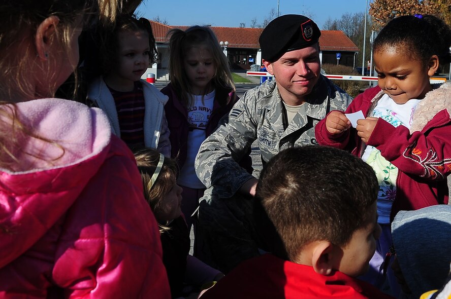 U.S. Air Force Senior Airman Truman Smith, Tactical Air Control Party, 2nd Air Support Operations Squadron, helps a group of children figure out a land navigation clue during the child development center's "Boot Camp Week", Rose Barracks, Vilseck Military Community, Germany, April 7, 2010. Members of the squadron participated in the "Boot Camp Week" which gave servicemember's children an opportunity to experience some military norms such as physical training, first aid, land navigation and tactical vehicle familarization in support of the Department of Defense's Month of the Military Child. (U.S. Air Force photo by Senior Airman Tony R. Ritter)