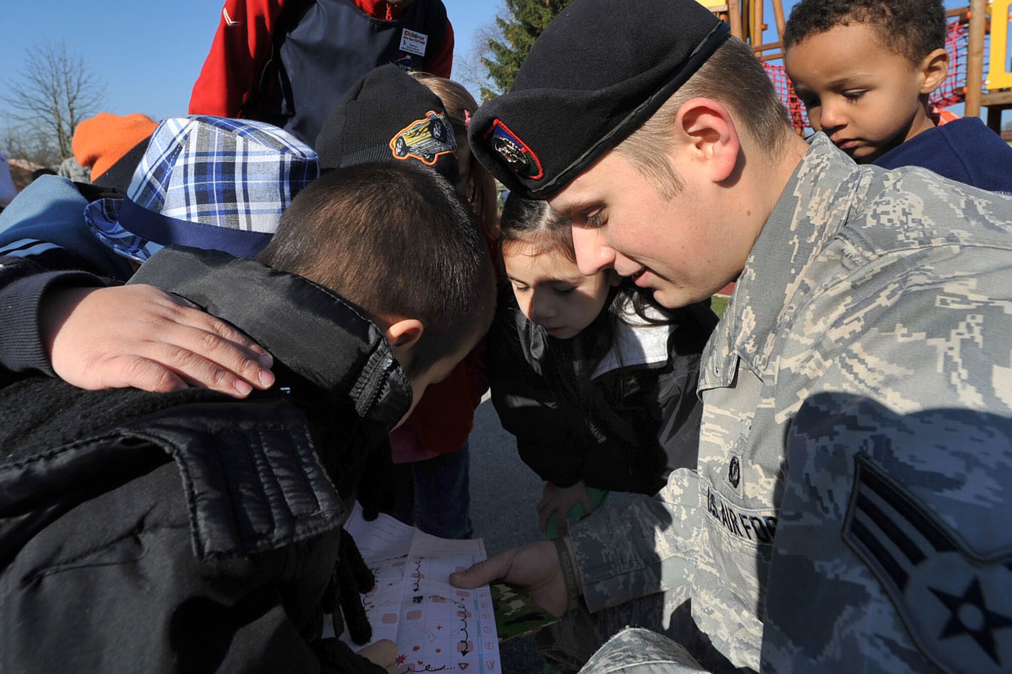 U.S. Air Force Senior Airman Joseph Schermetzkr, Tactical Air Control Party, 2nd Air Support Operations Squadron, helps a group of children read a map during the child development center's "Boot Camp Week", Rose Barracks, Vilseck Military Community, Germany, April 7, 2010. Members of the squadron participated in the "Boot Camp Week" which gave servicemember's children an opportunity to experience some military norms such as physical training, first aid, land navigation and tactical vehicle familarization in support of the Department of Defense's Month of the Military Child. (U.S. Air Force photo by Senior Airman Tony R. Ritter)
