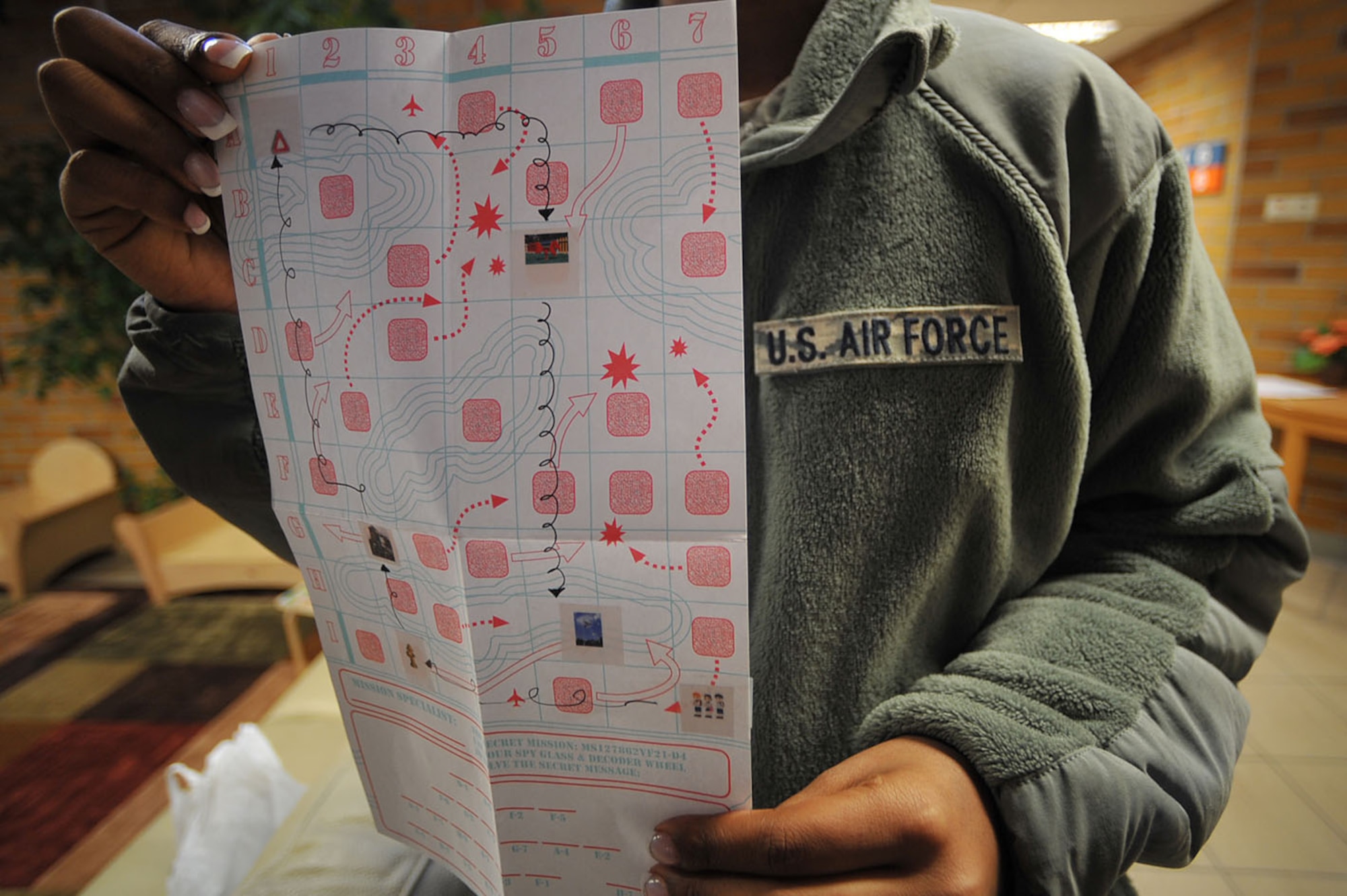 U.S. Air Force Staff Sgt. Andrea Beyer, 2nd Air Support Operations Squadron knowledge operator, holds up the land navigation map used during the child development center's "Boot Camp Week", Rose Barracks, Vilseck Military Community, Germany, April 7, 2010. Members of the squadron participated in the "Boot Camp Week" which gave servicemember's children an opportunity to experience some military norms such as physical training, first aid, land navigation and tactical vehicle familarization in support of the Department of Defense's Month of the Military Child. (U.S. Air Force photo by Senior Airman Tony R. Ritter) 