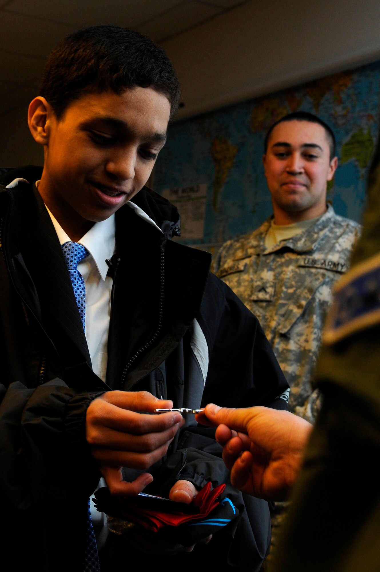 Cresencio Santos, brother of U.S. Army Pvt. Kevin Colindres, 8th Medical Logistics Company generator repair mechanic, Miesau Army Depot, Germany, receives aeronautical wings from U.S. Air Force Capt. Adam Wantuck, 37th Airlift Squadron flight commander, Ramstein Air Base, Germany, April 5, 2010. Santos and his mother, Rosa Figueroa, from Tampa, Fla., was given the opportunity to visit his brother because of the Make-A-Wish (MAW) Foundation, Germany in cooperation with MAW Foundation, Florida. Since 1980, the MAW Foundation has changed the lives of children with life-threatening medical conditions through its wish-granting work.  (U.S. Air Force photo by Airman 1st Class Brea Miller)