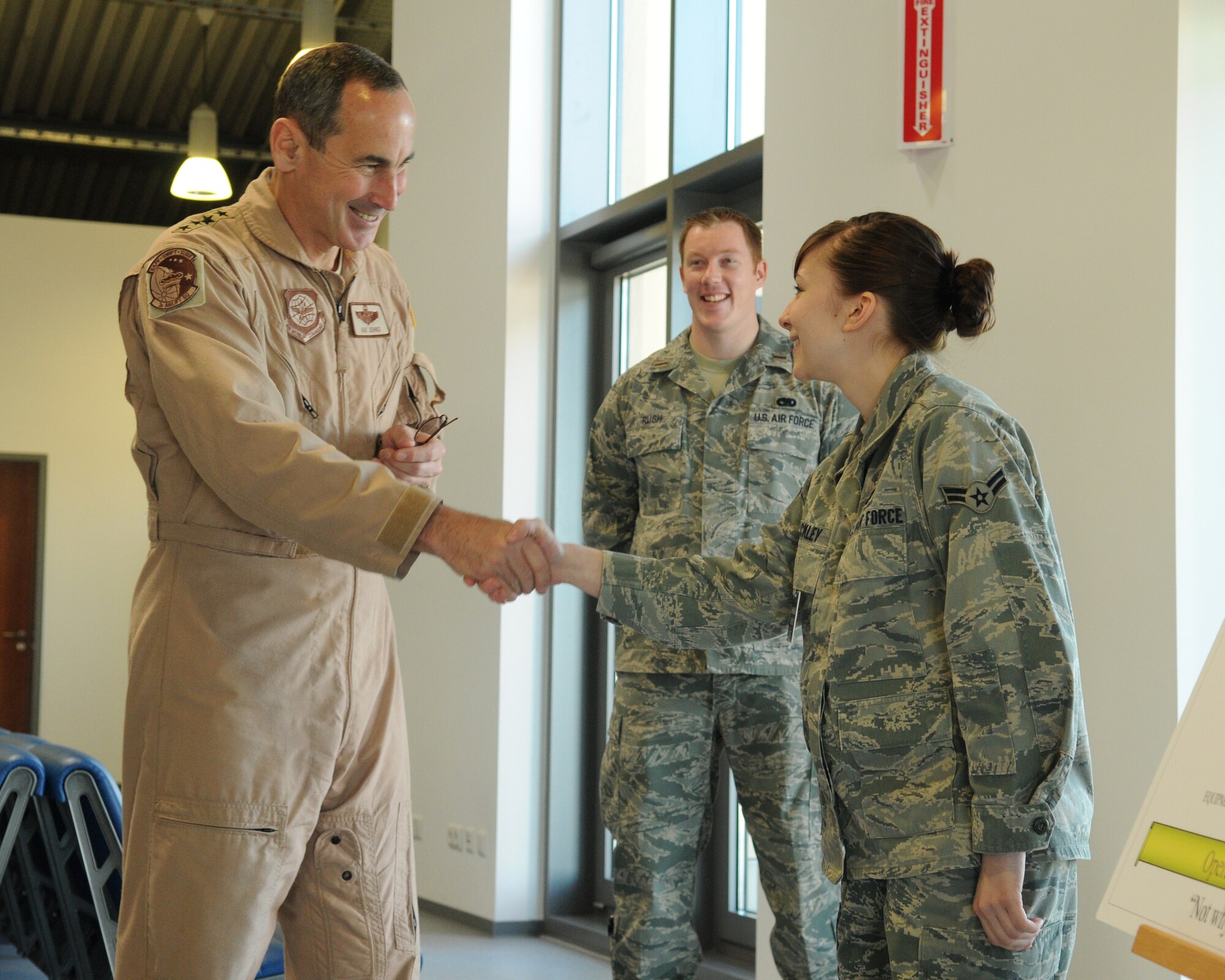 SPANGDAHLEM AIR BASE, Germany -- Gen. Ray Johns Jr., commander of Air Mobility Command, meets with  Airman 1st Class Leslie Ackley, 726th Air Mobility Squadron air mobility control center controller, April 6. During his vist, General Johns took the opportunity to tour various sections of the 726th AMS and personally meet the Airmen. (U.S. Air Force photo/Senior Airman Nathanael Callon)