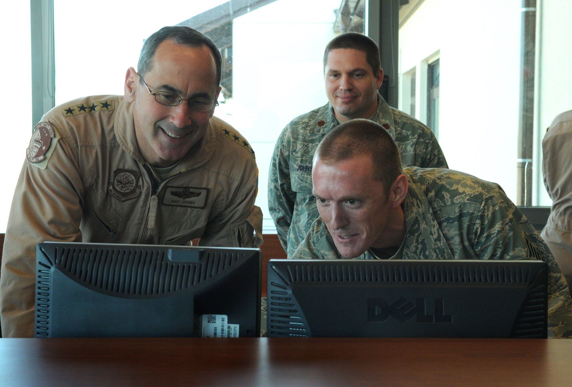 SPANGDAHLEM AIR BASE, Germany -- Gen. Ray Johns Jr., commander of Air Mobility Command, observes as Staff Sgt. Jacob Mulders, 726th Air Mobility Squadron maintenance operations center controller, works on a computer system April 6.  During his visit, General Johns took the opportunity to tour various sections of 726th AMS and personally meet the Airmen. (U.S. Air Force photo/Senior Airman Nathanael Callon)
