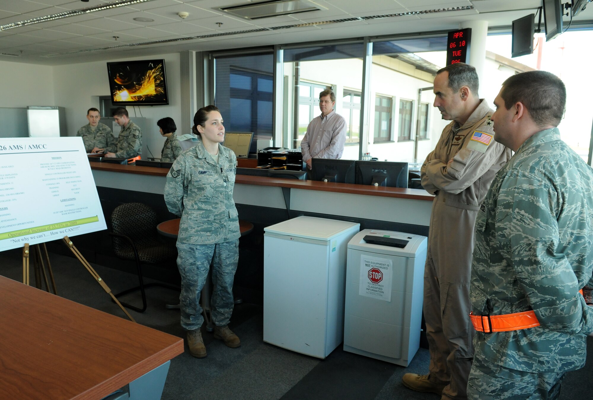 SPANGDAHLEM AIR BASE, Germany -- Staff Sgt. Christina Camp, 726th Air Mobility Squadron air mobility control center controller, speaks with Gen. Ray Johns Jr., commander of Air Mobility Command, about her work center April 6.  During his visit, General Johns  took the opportunity to tour various sections of the 726th AMS and personally meet the Airmen. (U.S. Air Force photo/Senior Airman Nathanael Callon)