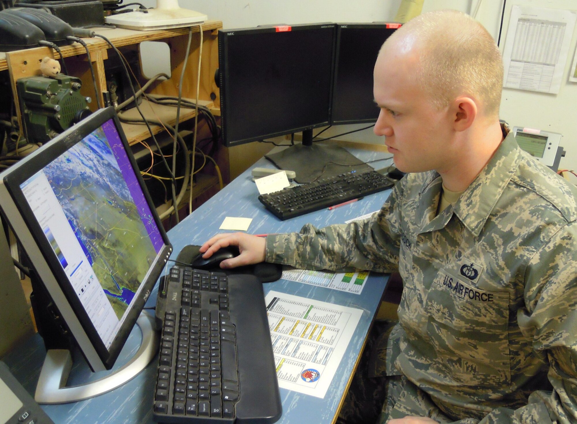 JOINT BASE BALAD, Iraq -- Tech Sgt. Mike Adcock, a Task Force 38 weather forecaster, monitors a dust storm in northern Iraq on a satellite-produced image. (U.S. Army photo by Staff Sgt. Jeff Lowry)