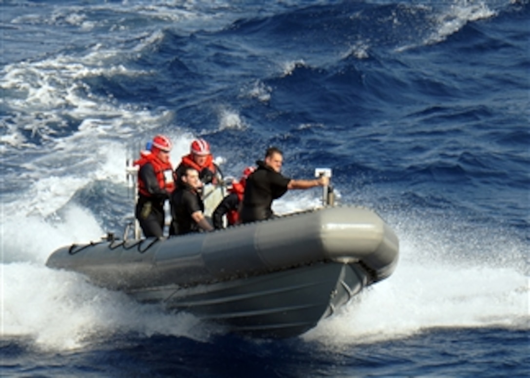 U.S. Navy sailors assigned to the aircraft carrier USS George H.W. Bush (CVN 77) return to the ship underway in the Atlantic Ocean conducting training exercises after conducting a man-overboard recovery drill on April 5, 2010.  