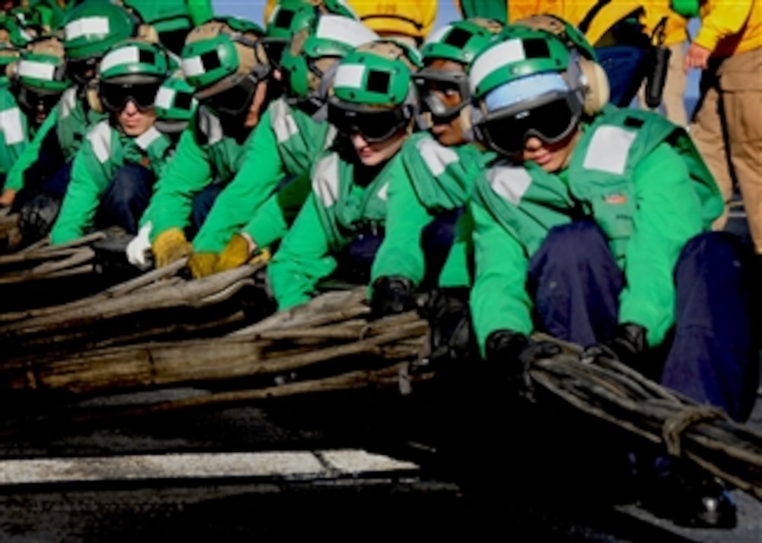 U.S. Navy sailors assigned to the air department of the aircraft carrier USS George H.W. Bush (CVN 77) set up the aircraft barricade during a drill on the flight deck of the ship underway in the Atlantic Ocean conducting training on April 3, 2010.  