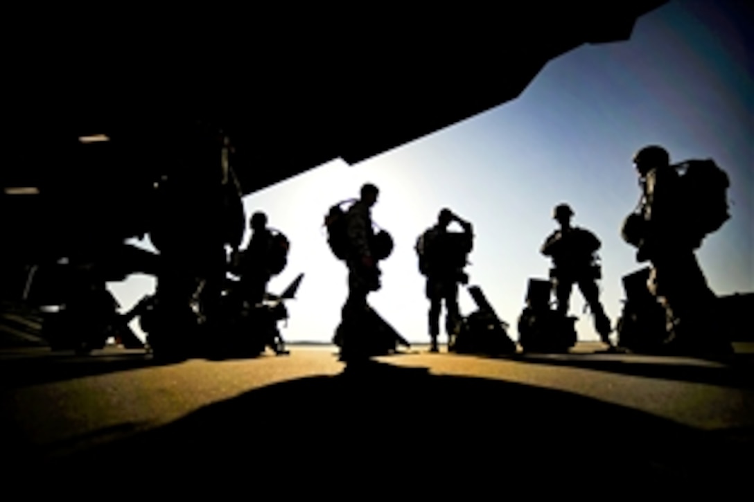 U.S. Air Force airmen prepare to fly with the 317th Air Reserve Squadron on Charleston Air Force Base, S.C., and perform static line drops during a training mission over North Field, S.C., April 5, 2010. The airmen are assigned to the 820th Security Forces Group on Moody Air Force Base, Ga.