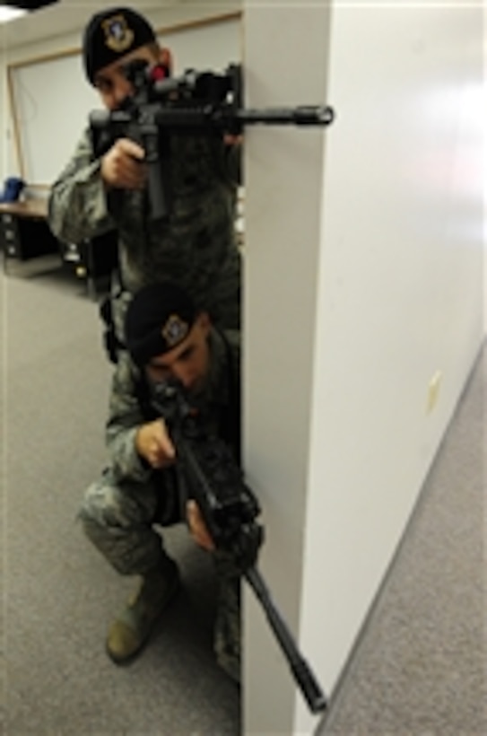 U.S. Air Force Tech. Sgt. Joel Meyer (top) and Senior Airman Jacob Lacefield, both with the 28th Security Forces Squadron, participate in a threat scenario during training at Ellsworth Air Force Base, S.D., on April 5, 2010.  