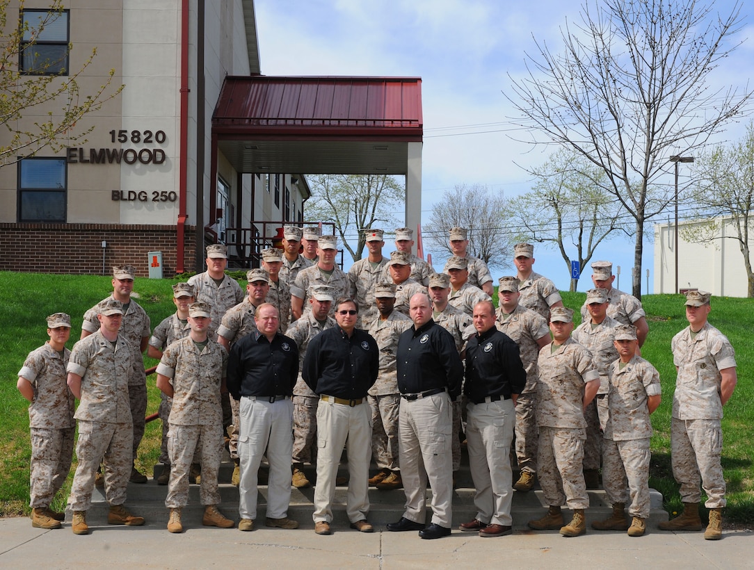 Students from Marine Forces Reserve and civilian course instructors for an antiterrorism training class take a group photograph at a Marine Corps facility here April 8.  Graduates received Level II AT certification and are designated as unit antiterrorism officers.