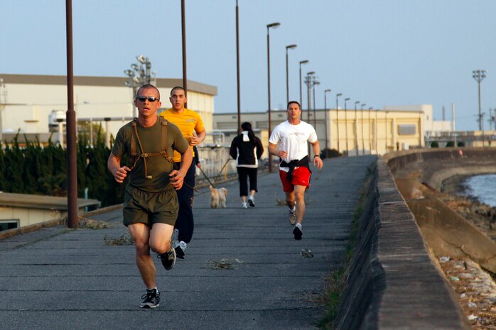 Sgt. Adam Kruse, station outside plant chief, approaches the three-mile mark on the seawall here during a combined physical fitness and combat fitness test competition April 8. Kruse took first place during the competition and won the chance to participate in a tandem parachute during jump rehearsals prior to Friendship Day on May 5.