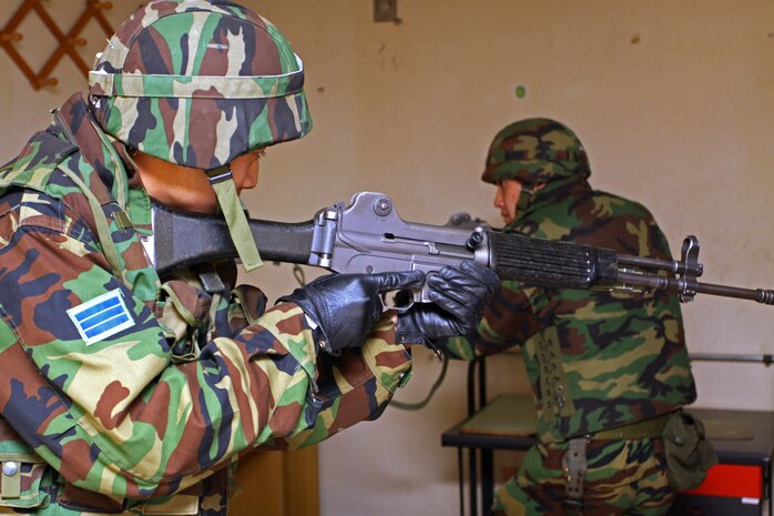 YECHON AIR BASE, Republic of Korea - Two Republic of Korea airmen clear a room during military operations in urban terrain training here April 9. The ROK Air Force trained with Marines in MOUT for approximately one week as part of Exercise Foal Eagle 2010, as well as completed enemy prisoners of war training, vehicle and personnel searches, and riot control.