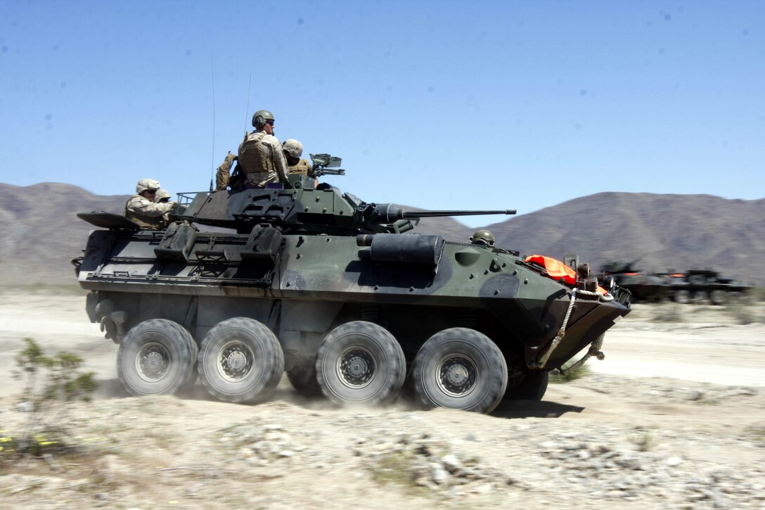 Marines with 3rd Light Armored Reconnaissance Battalion give spouses a ride in a light armored vehicle April 9 during the battalion’s Jane Wayne Day. The battalion held the event at Combat Center Range 500.