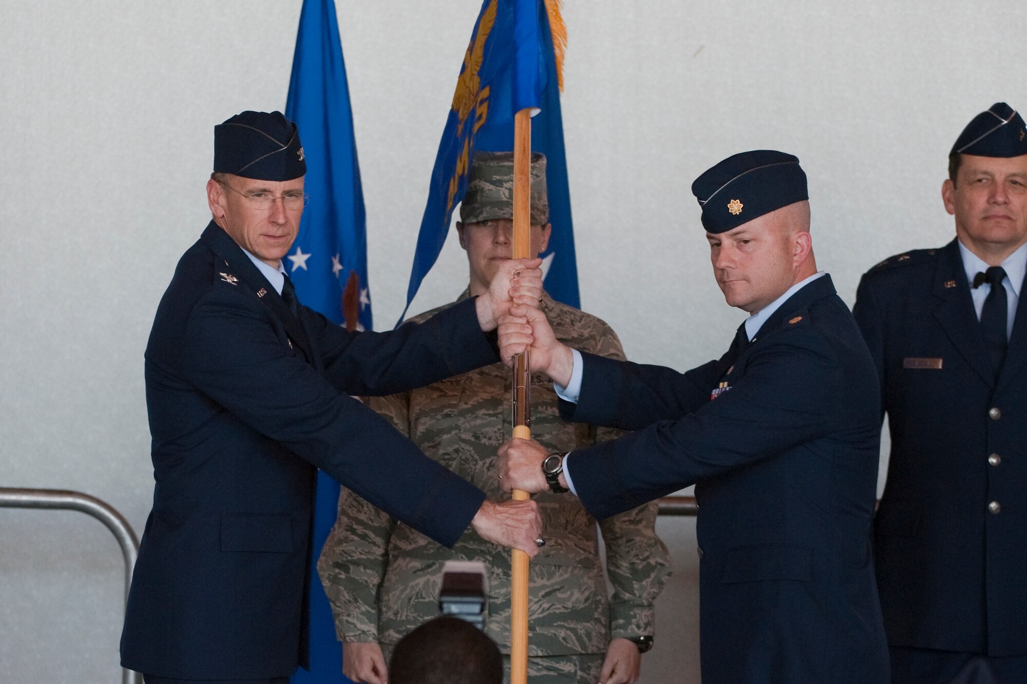HOLLOMAN AIR FORCE BASE, N.M. -- Col. Donald Lindberg, 44th Fighter Group commander, passes the passes the 44th Aircraft Maintenance Squadron guidon to the incoming commander, Maj. William Magee, during the group's formal activation ceremony April 9, 2010. The 44th Fighter Group traces its lineage to the famed World War II 44th Bombardment Group (Heavy) originally activated in January 1941 at MacDill Army Air Field in Tampa, Fla., and flew the then state-of-the-art B-24 Liberator. Sixty-nine years later, the 44th Fighter Group is the only Air Force Reserve organization to be selected to fly the U.S. Air Force's premier air superiority fighter, the F-22 Raptor. (U.S. Air Force photo by Staff Sgt. Joe Laws / Released)