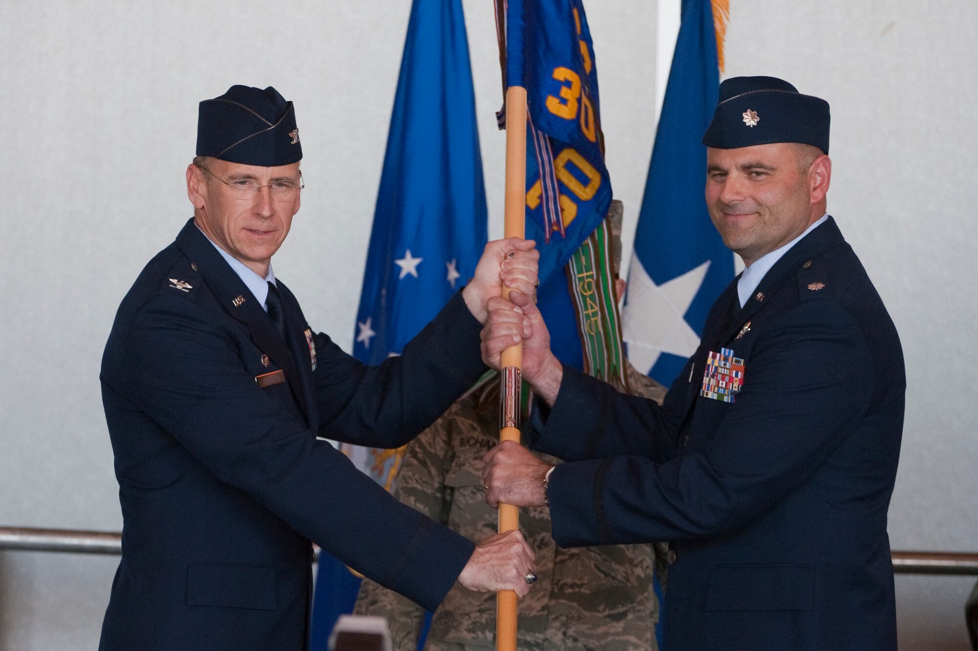 HOLLOMAN AIR FORCE BASE, N.M. -- Col. Donald Lindberg, 44th Fighter Group commander, passes the 301st Fighter Squadron guidon to the incoming commander, Lt. Col. Kent Furman, during the group's formal activation ceremony April 9, 2010. The 44th Fighter Group traces its lineage to the famed World War II 44th Bombardment Group (Heavy) originally activated in January 1941 at MacDill Army Air Field in Tampa, Fla., and flew the then state-of-the-art B-24 Liberator. Sixty-nine years later, the 44th Fighter Group is the only Air Force Reserve organization to be selected to fly the U.S. Air Force's premier air superiority fighter, the F-22 Raptor. (U.S. Air Force photo by Staff Sgt. Joe Laws / Released)