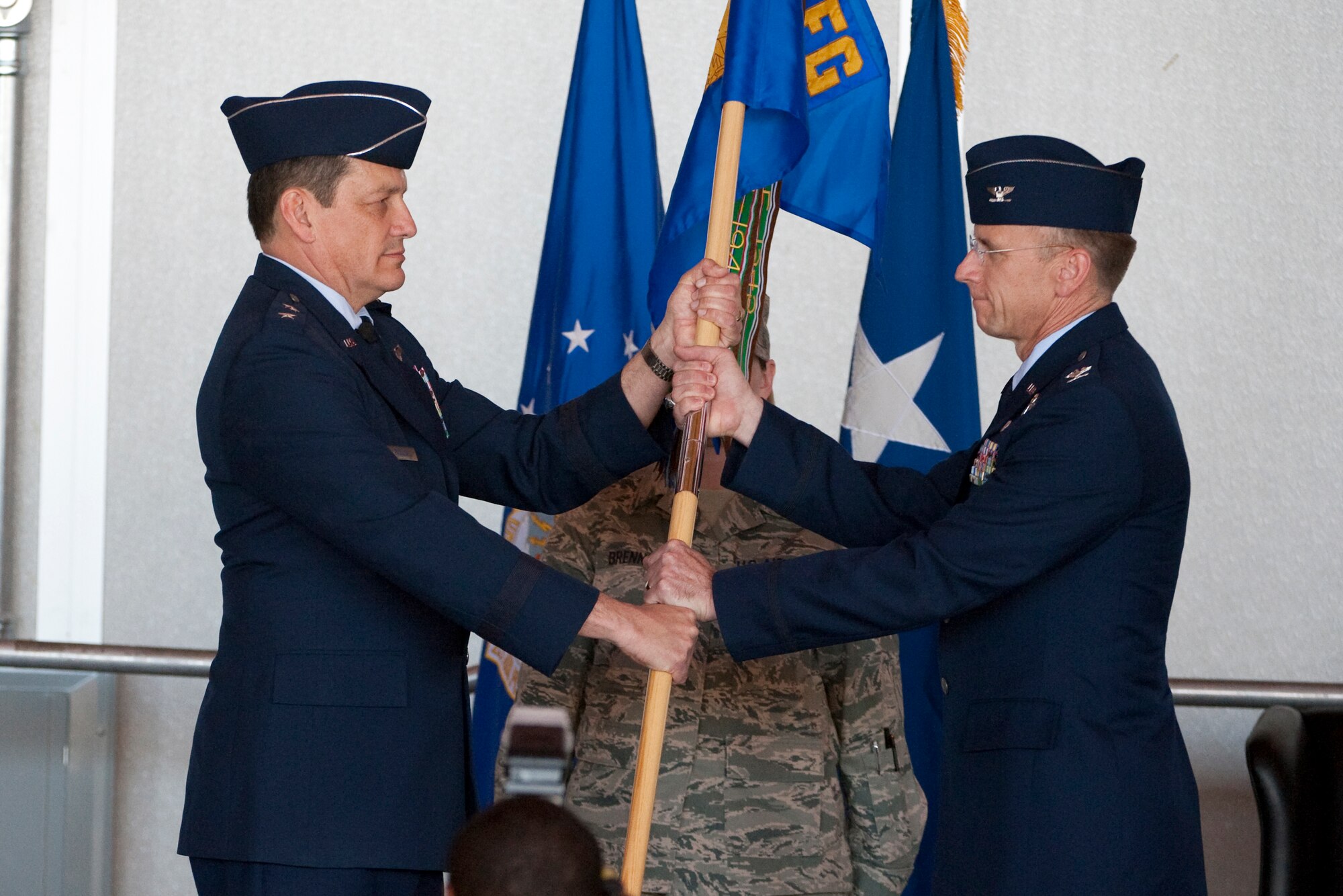 HOLLOMAN AIR FORCE BASE, N.M. -- Maj. Gen. Frank Padilla passes the 44th Fighter Group guidon to the incoming commander, Col. Donald Lindberg, during the group's formal activation ceremony April 9, 2010. The 44th Fighter Group traces its lineage to the famed World War II 44th Bombardment Group (Heavy) originally activated in January 1941 at MacDill Army Air Field in Tampa, Fla., and flew the then state-of-the-art B-24 Liberator. Sixty-nine years later, the 44th Fighter Group is the only Air Force Reserve organization to be selected to fly the U.S. Air Force's premier air superiority fighter, the F-22 Raptor. (U.S. Air Force photo by Staff Sgt. Joe Laws / Released)