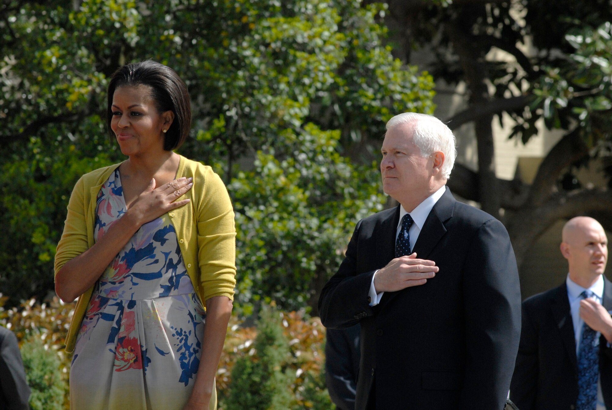 First lady Michelle Obama (left) joins host, Defense Secretary Robert Gates, as the National Anthem plays during a gathering April 9, 2010, in Washington, D.C.  The first lady visited the Pentagon and thanked the military personnel and civilian employees serving at the Defense Department. (U.S. Air Force photo/Tech. Sgt. Amaani Lyle)