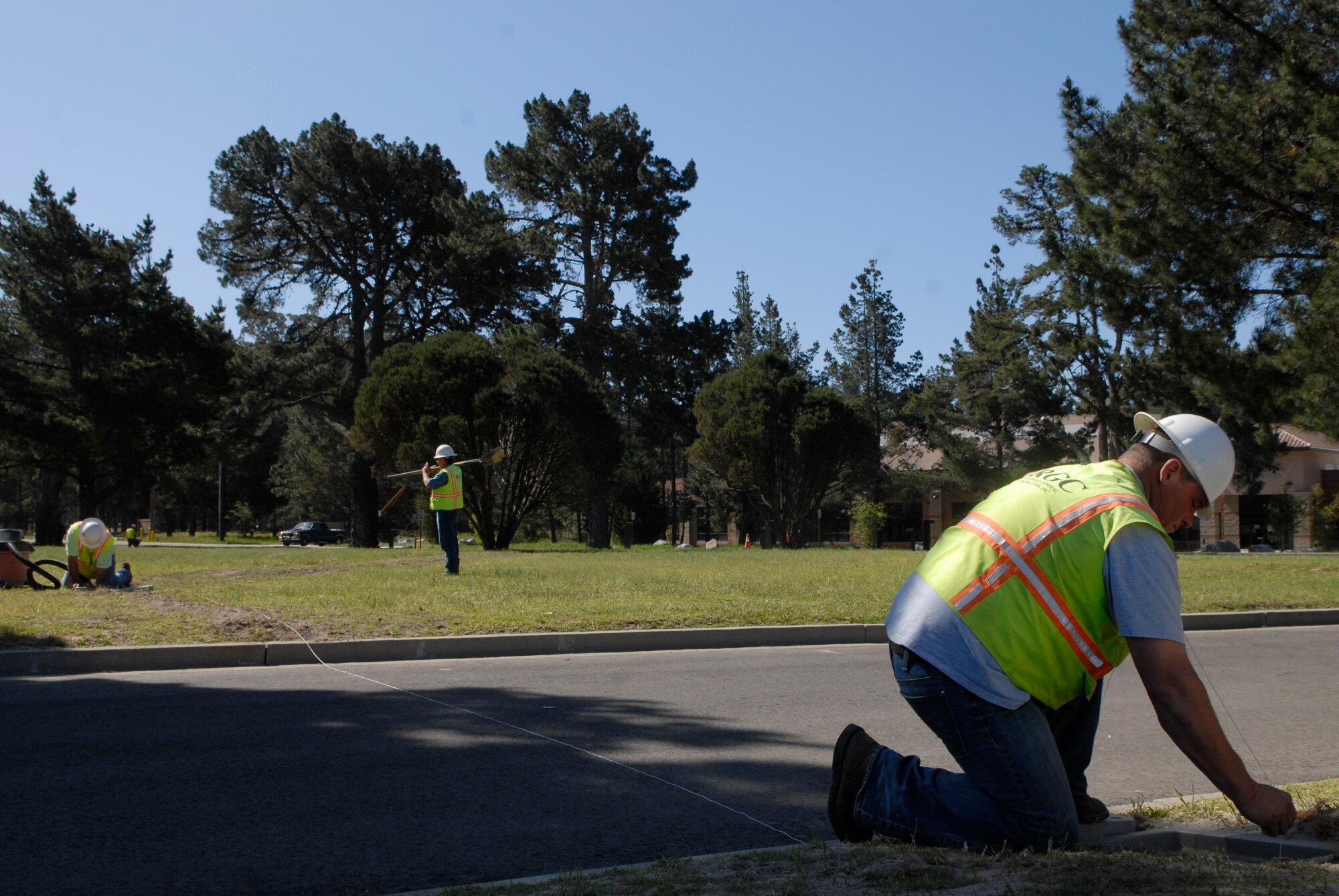 VANDENBERG AIR FORCE BASE, Calif. -- Chad Lorton, a contractor with the Rockwood General Contractors company, measures the area with Jeff Whitaker, a RGC contractor, to put new light poles in the ground near the Vandenberg Fitness Center here Thursday, April 8, 2010.  (U.S. Air Force photo/Senior Airman Andrew Satran) 

 
