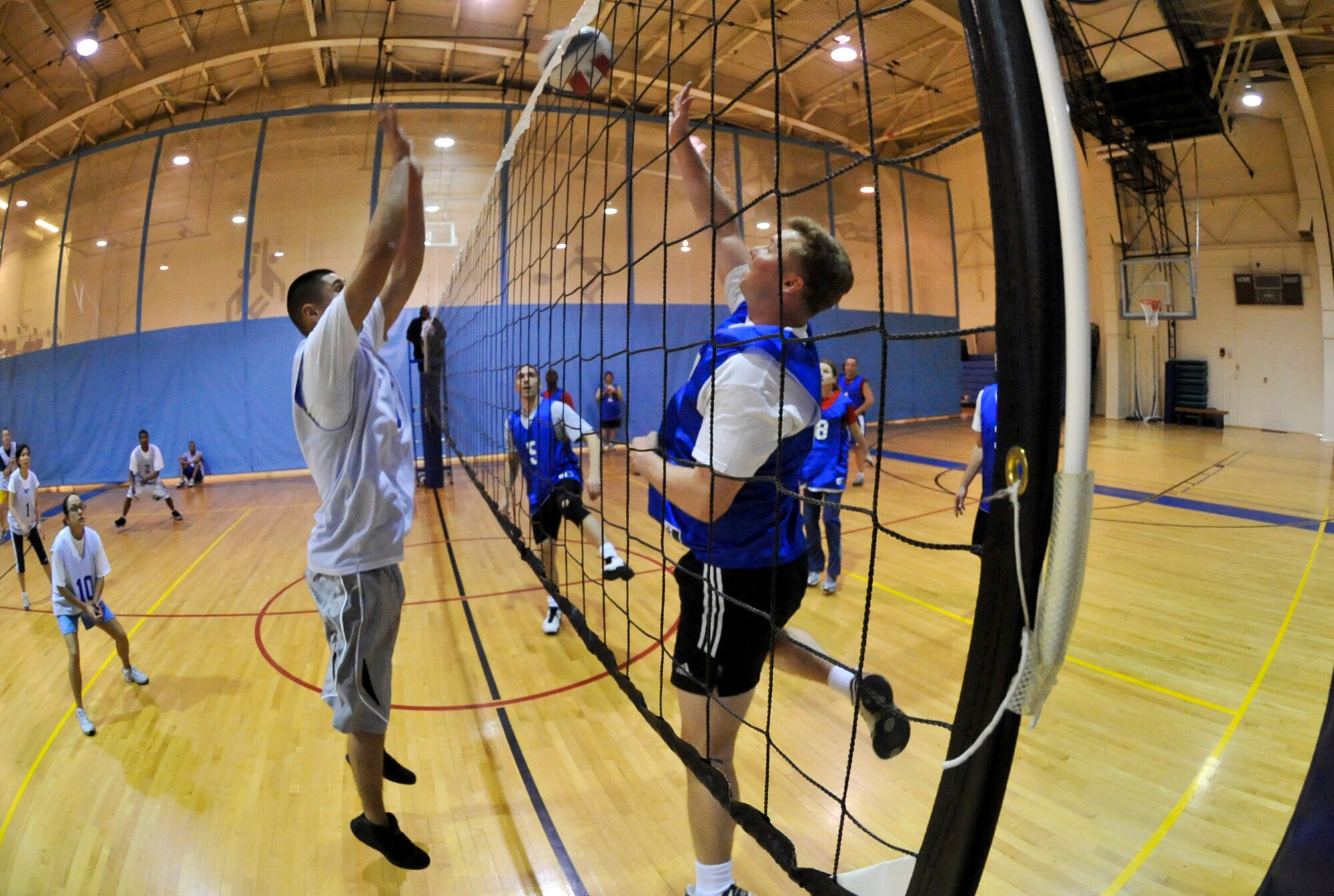 ELMENDORF AIR FORCE BASE, Alaska – Jose Camacho, 3rd Wing Legal Office (left), attempts to block a spike from a member of the 517th Airlift Squadron, April 8, during a game of intramural volleyball. The 517th AS mauled the 3rd WG JA taking two straight sets to win the game. (Air Force photo by Airman 1st Class Christopher Gross)