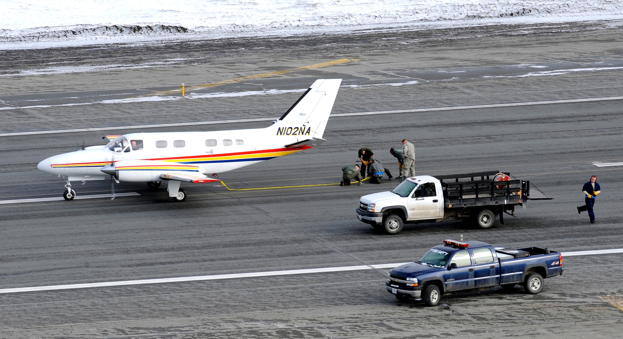 Aircraft Maintainers attach the cable of an air-to-air gunnery target banner to a Cessna Conquest at Elmendorf Air Force Base, Alaska, prior to a live fire training mission over an Alaskan range, April 7. The air-to-air gun mission consisted of the Cessna towing an aerial banner 2,000 feet behind it while two F-15 Eagles took turns firing at the banner. The mission validated the 3rd Operations Group's air-to-air gunnery capability and was their first live fire gunnery mission here. (Air Force photo by Staff Sgt. Brian Ferguson)