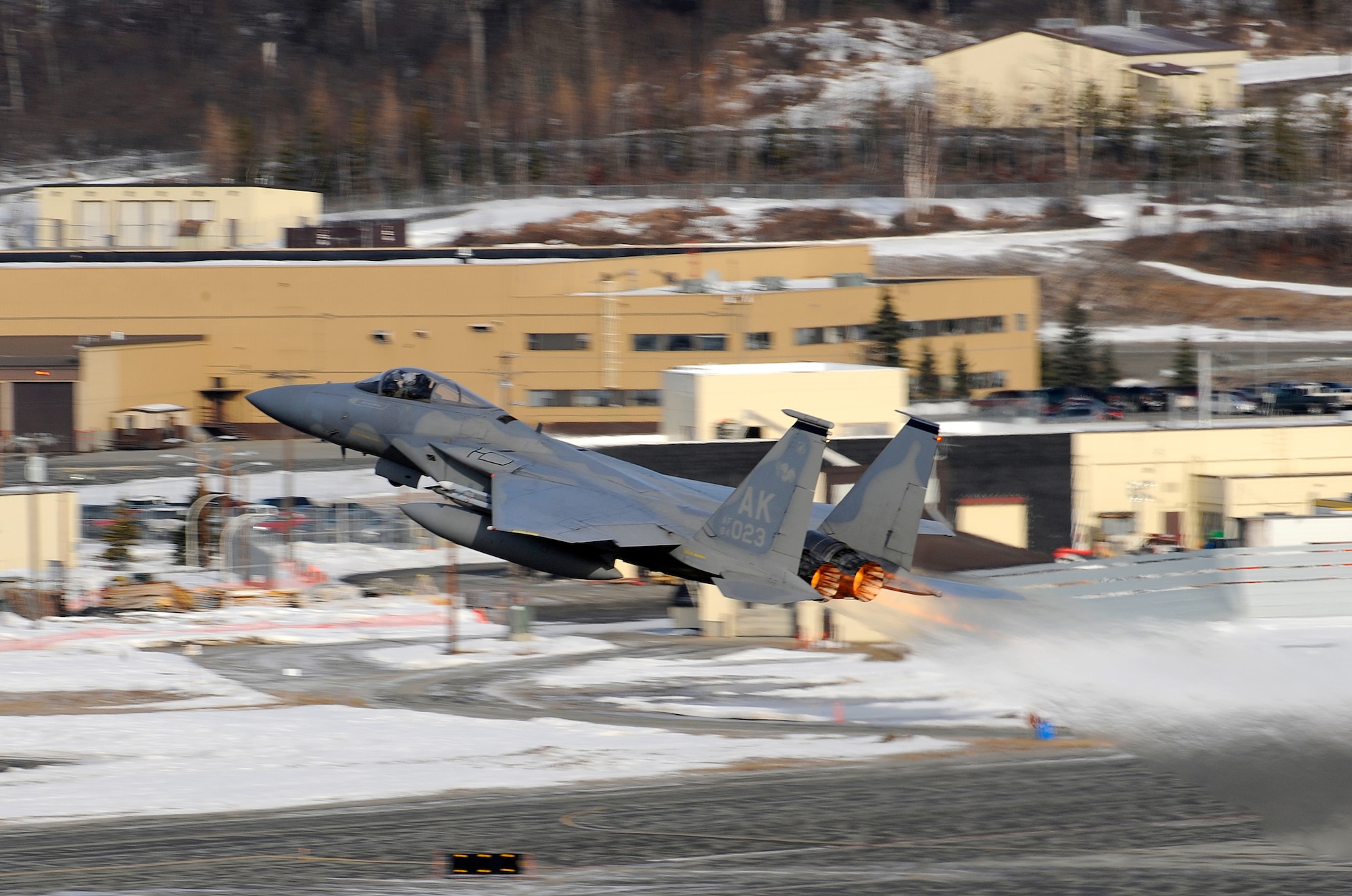 An F-15 Eagle takes off at Elmendorf Air Force Base, Alaska, prior to a live fire training mission over an Alaskan range, April 7. The air-to-air gun mission consisted of a Cessna Conquest towing an aerial banner 2,000 feet behind it while two F-15 Eagles took turns firing at the banner. The mission validated the 3rd Operations Group's air-to-air gunnery capability and was their first live fire gunnery mission here. (Air Force photo by Staff Sgt. Brian Ferguson)