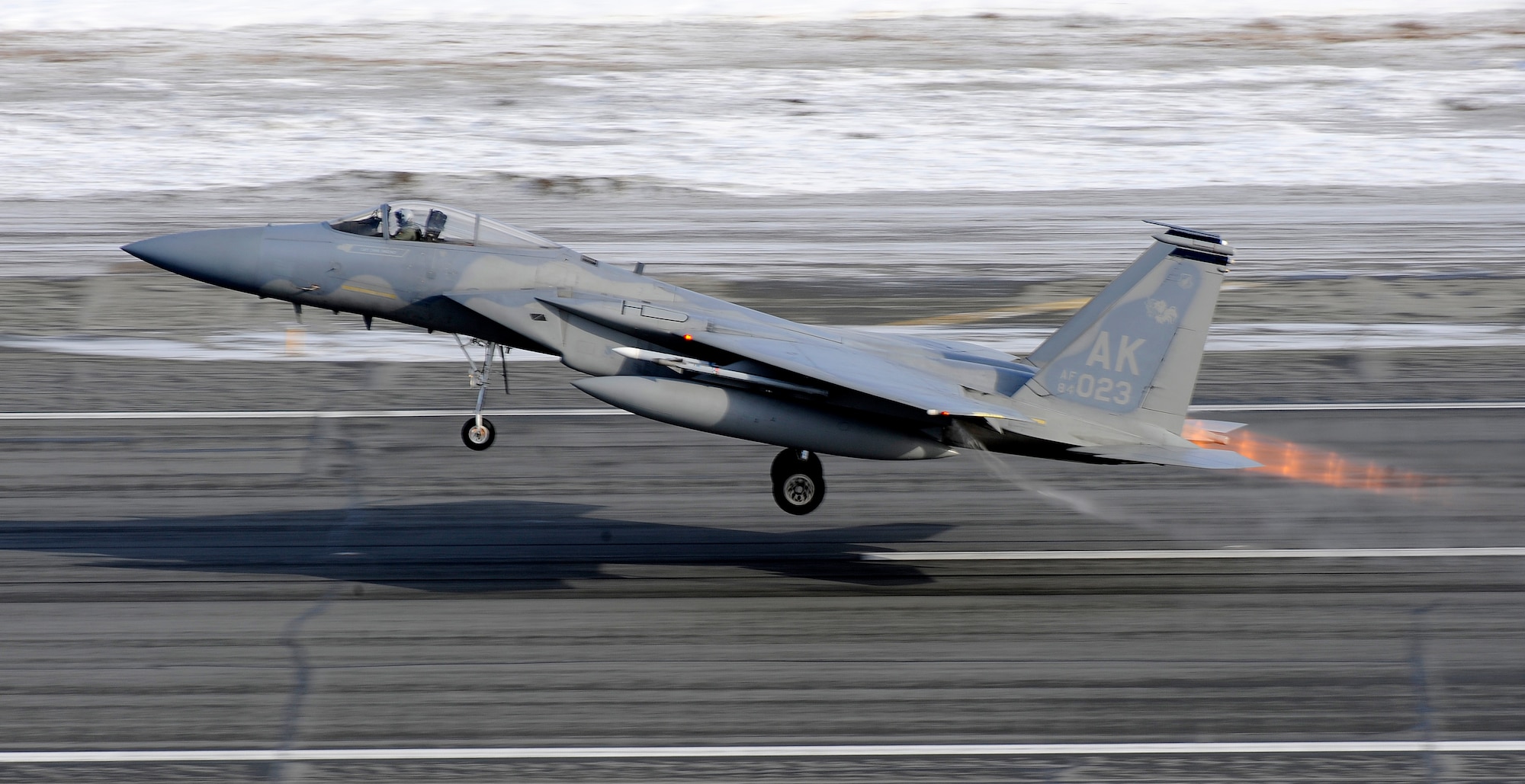 An F-15 Eagle takes off at Elmendorf Air Force Base, Alaska, prior to a live fire training mission over an Alaskan range, April 7. The air-to-air gun mission consisted of a Cessna Conquest towing an aerial banner 2,000 feet behind it while two F-15 Eagles took turns firing at the banner. The mission validated the 3rd Operations Group's air-to-air gunnery capability and was their first live fire gunnery mission here. (Air Force photo by Staff Sgt. Brian Ferguson)